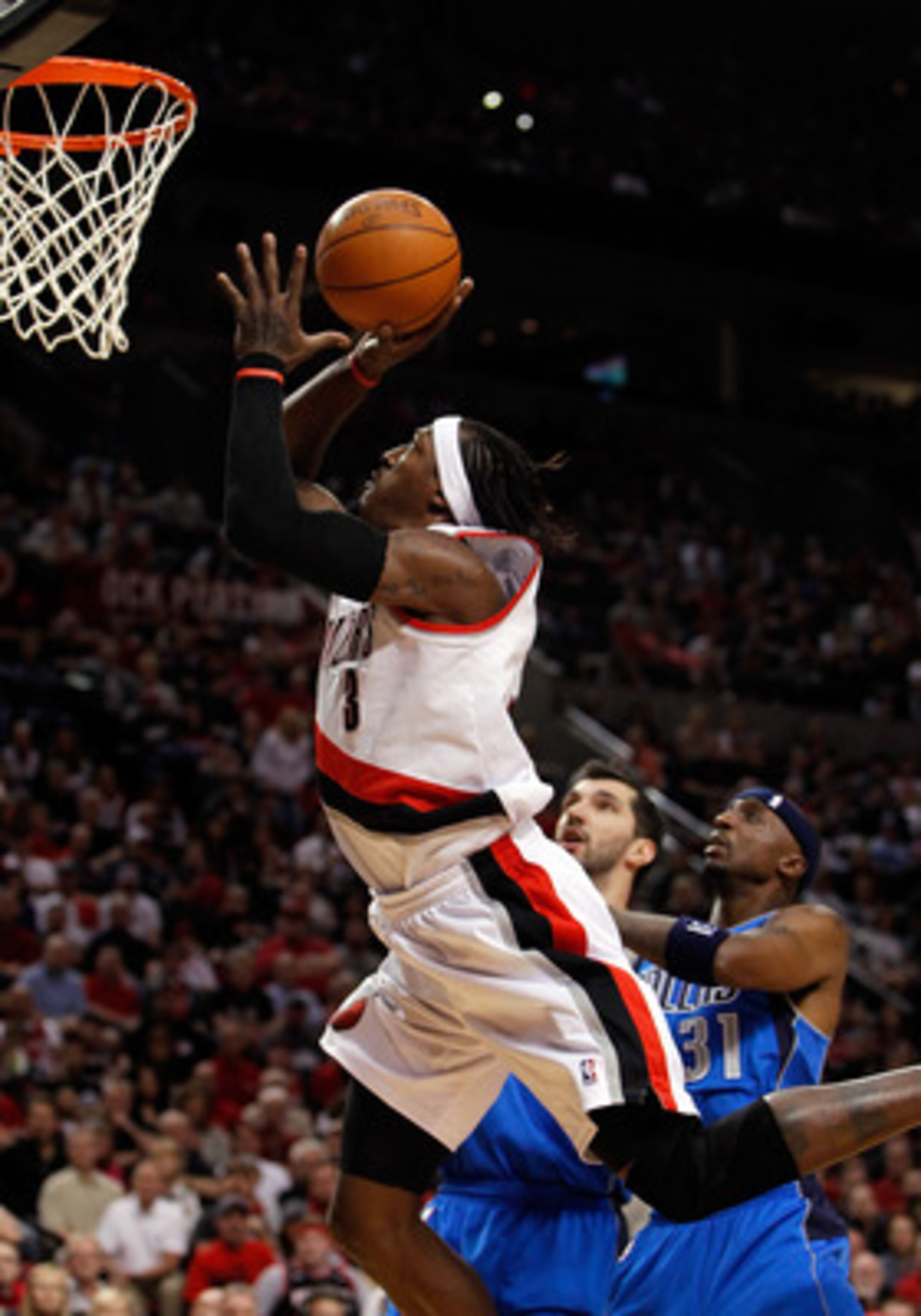 PORTLAND, OR - APRIL 23: Gerald Wallace #3 of the Portland Trail Blazers lays up the ball against the Dallas Mavericks in Game Four of the Western Conference Quarterfinals in the 2011 NBA Playoffs on April 23, 2011 at the Rose Garden in Portland, Oregon. PORTLAND, OR - APRIL 23: Gerald Wallace #3 of the Portland Trail Blazers lays up the ball against the Dallas Mavericks in Game Four of the Western Conference Quarterfinals in the 2011 NBA Playoffs on April 23, 2011 at the Rose Garden in Portland, Oregon.