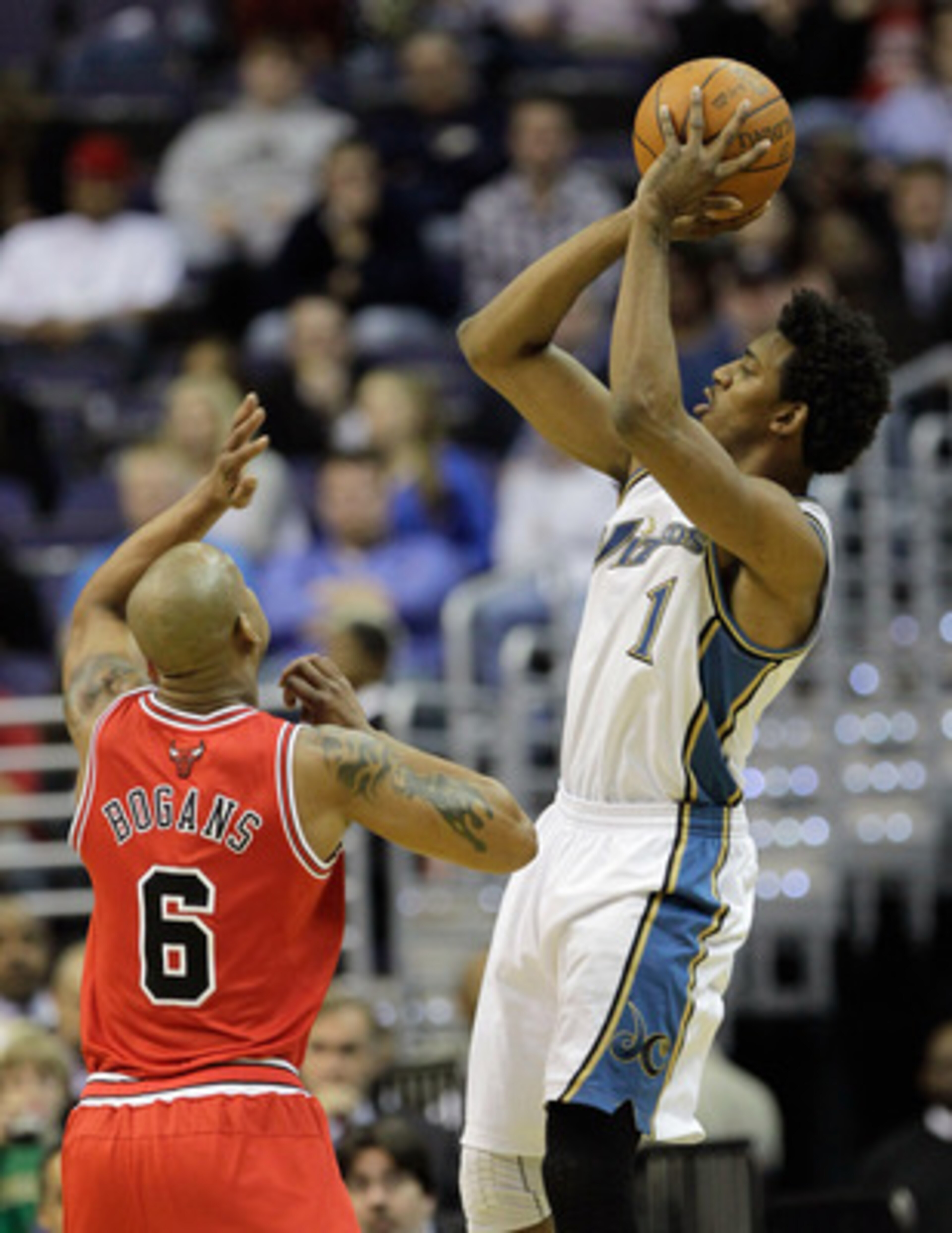WASHINGTON, DC - FEBRUARY 28: Nick Young #1 of the Washington Wizards shoots over Keith Bogans #6 of the Chicago Bulls at the Verizon Center in Washington on February 28, 2011 in Washington, DC. NOTE TO USER: User expressly acknowledges and agrees that, b WASHINGTON, DC - FEBRUARY 28: Nick Young #1 of the Washington Wizards shoots over Keith Bogans #6 of the Chicago Bulls at the Verizon Center in Washington on February 28, 2011 in Washington, DC. NOTE TO USER: User expressly acknowledges and agrees that, b