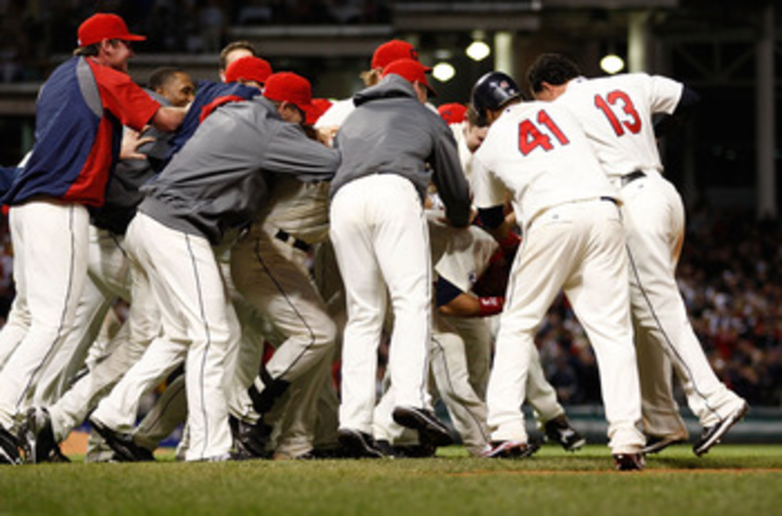 CLEVELAND - APRIL 30:  Members of the Cleveland Indians mob their teammate Orlando Cabrera #20 after he hit a walk-off game winning single in the 13th inning against the Detroit Tigers during the game on April 30, 2011 at Progressive Field in Cleveland, O
