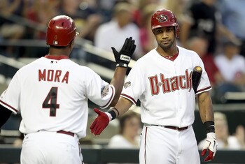 PHOENIX, AZ - APRIL 28:  Chris Young #24 of the Arizona Diamondbacks high fives teammate Melvin Mora #4 after scoring against the Chicago Cubs during the first inning of the Major League Baseball game at Chase Field on April 28, 2011 in Phoenix, Arizona.