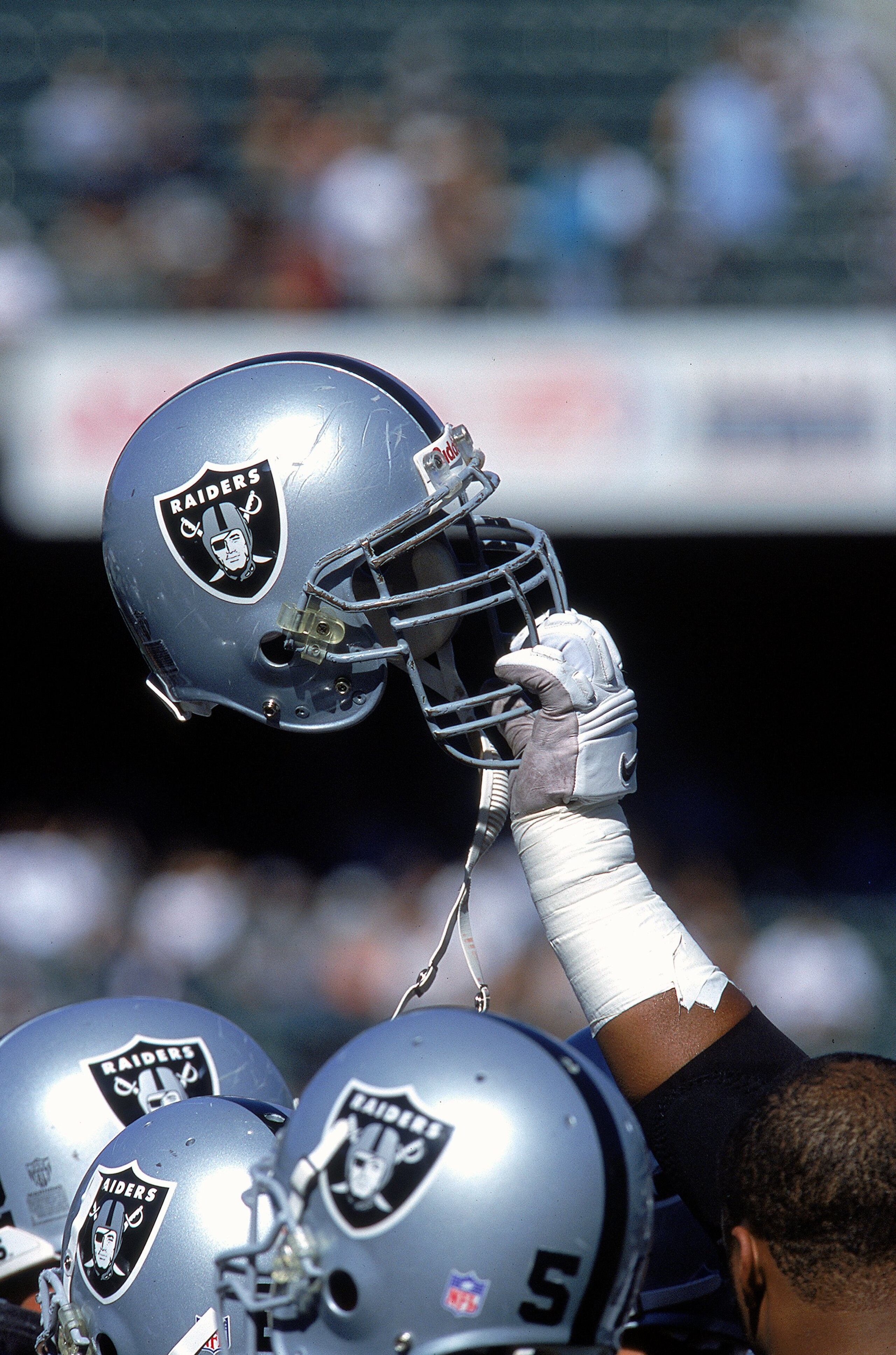 24 Oct 1999: A view of the Oakland Raiders helmet as it is raise up in a huddle during a game against the New York Jets at the Network Coliseum in Oakland, California. The Raiders defeated the Jets 24-23. Mandatory Credit: Jon Ferrey  /Allsport