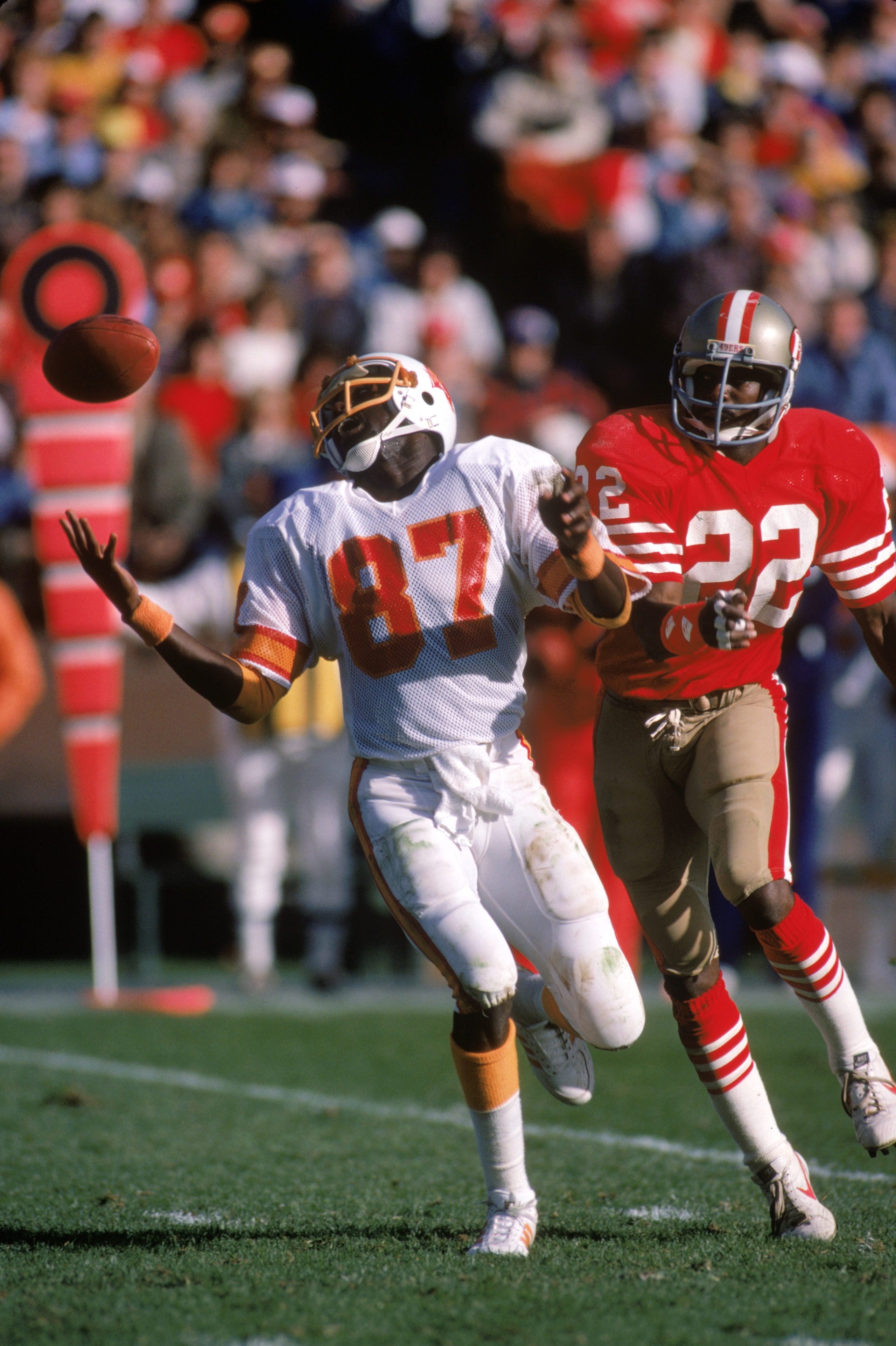 SAN FRANCISCO - NOVEMBER 18:  Wide receiver Gerald Carter #87 of the Tampa Bay Buccaneers attempts to make a catch against defensive back Dwight Hicks #22 of the San Francisco 49ers during a game at Candlestick Park on November 18, 1984 in San Francisco, 