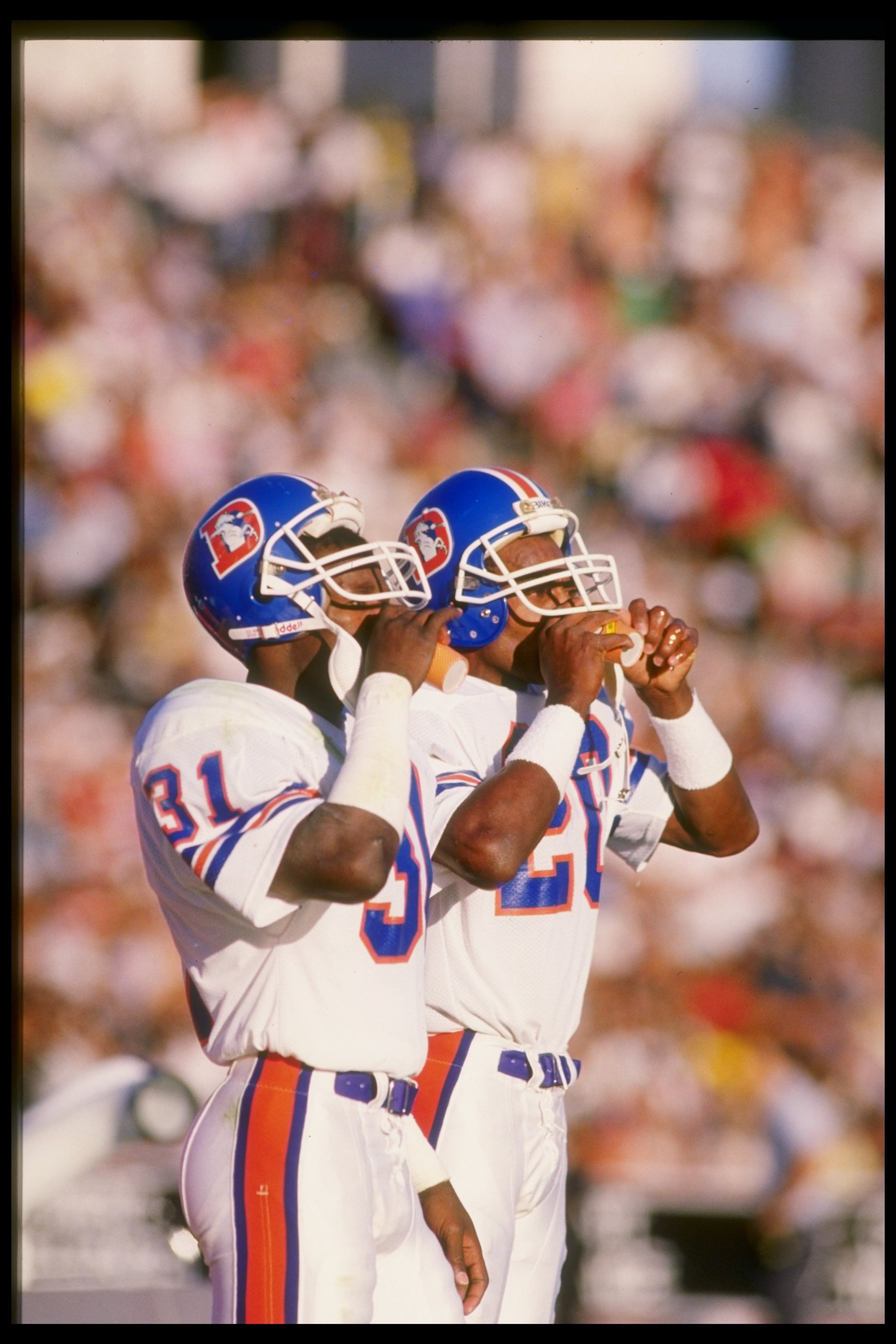 2 Nov 1986:  Defensive backs Louis Wright (right) and Mike Harden of the Denver Broncos adjust their helmets during a game against the Los Angeles Raiders at the Los Angeles Memorial Coliseum in Los Angeles, California.  The Broncos won the game 21-10. Ma