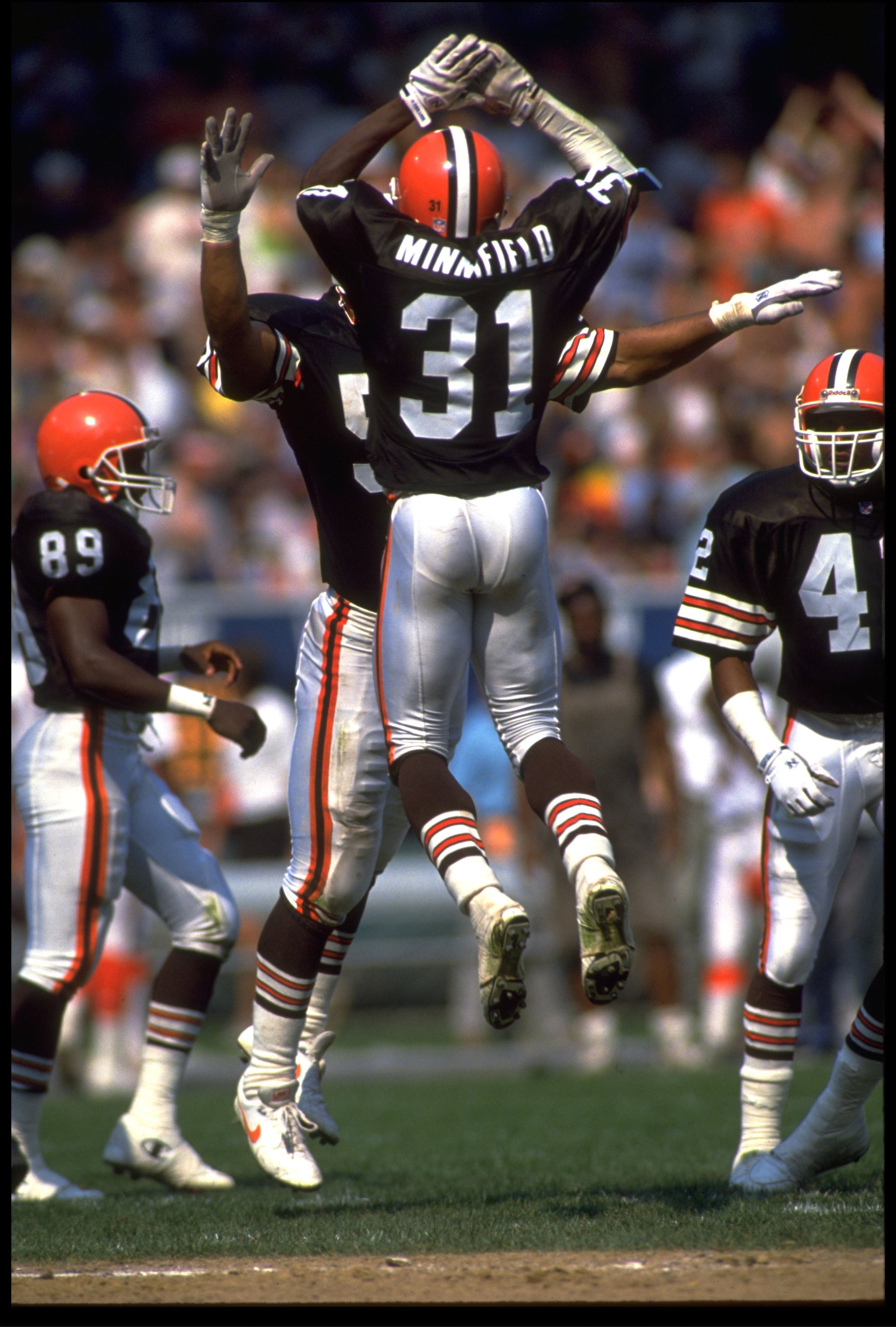 15 Sep 1991: FRANK MINNIFIELD, #31, DEFENSIVE BACK FOR THE CLEVELAND BROWNS, JUMPS FOR A HIGH FIVE DURING THEIR 14-13 AFC CENTRAL DIVISION WIN OVER THE CINCINNATI BENGALS AT CLEVELAND STADIUM IN CLEVELAND, OHIO.