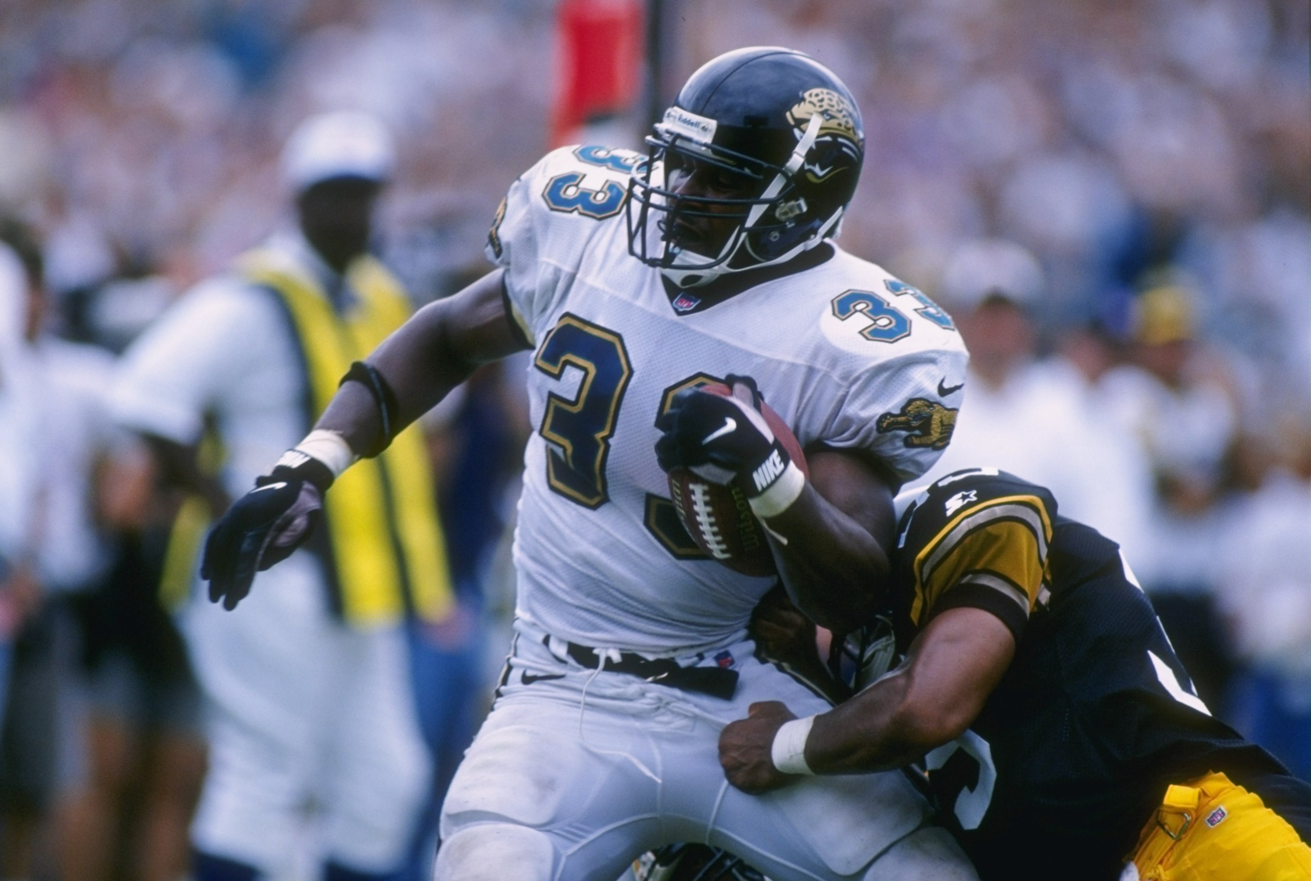 1 Sep 1996: Running back James Brown #33 of the Jacksonville Jaguars attempts to power through the tackle of defensive back Carnell Lake #37 of the Pittsburgh Steelers during a carry in the Jaguars 24-9 victory over the Steelers at Jacksonville Stadium in
