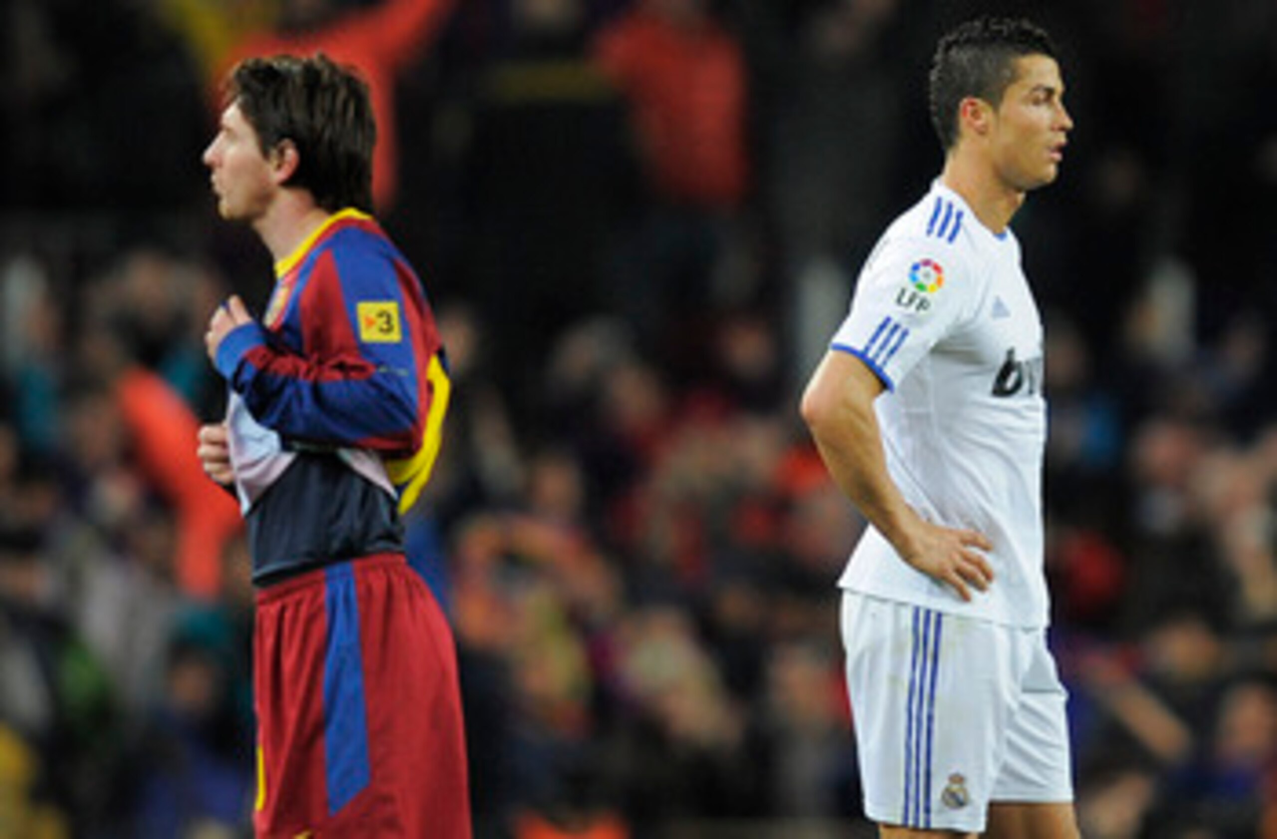 BARCELONA, SPAIN - NOVEMBER 29:  Cristiano Ronaldo of Real Madrid (R) and Lionel Messi of FC Barcelona look on during the La Liga match between Barcelona and Real Madrid at the Camp Nou Stadium on November 29, 2010 in Barcelona, Spain.  Barcelona won the