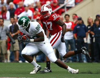 MADISON, WI - SEPTEMBER 26:  Dion Sims #80 of the Michigan State Spartans makes a catch in front of Kevin Claxton #37 of the Wisconsin Badgers on September 26, 2009 at Camp Randall Stadium in Madison, Wisconsin. Wisconsin defeated Michigan State 38-30. (P