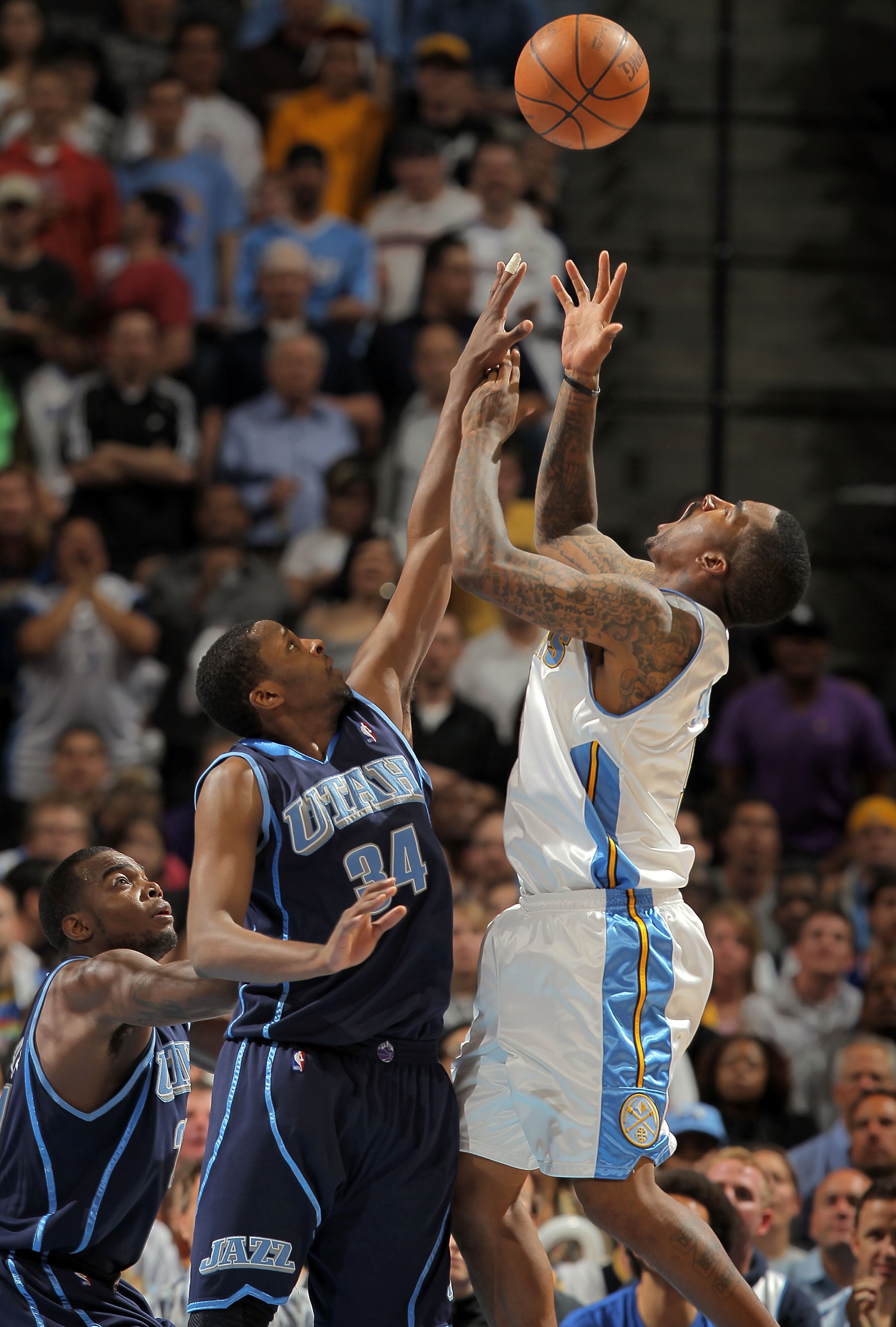 DENVER - APRIL 28:  J. R. Smith #5 of the Denver Nuggets looses control of the ball while under pressure from C.J. Miles #34 of the Utah Jazz in Game Five of the Western Conference Quarterfinals of the 2010 NBA Playoffs at the Pepsi Center on April 28, 20