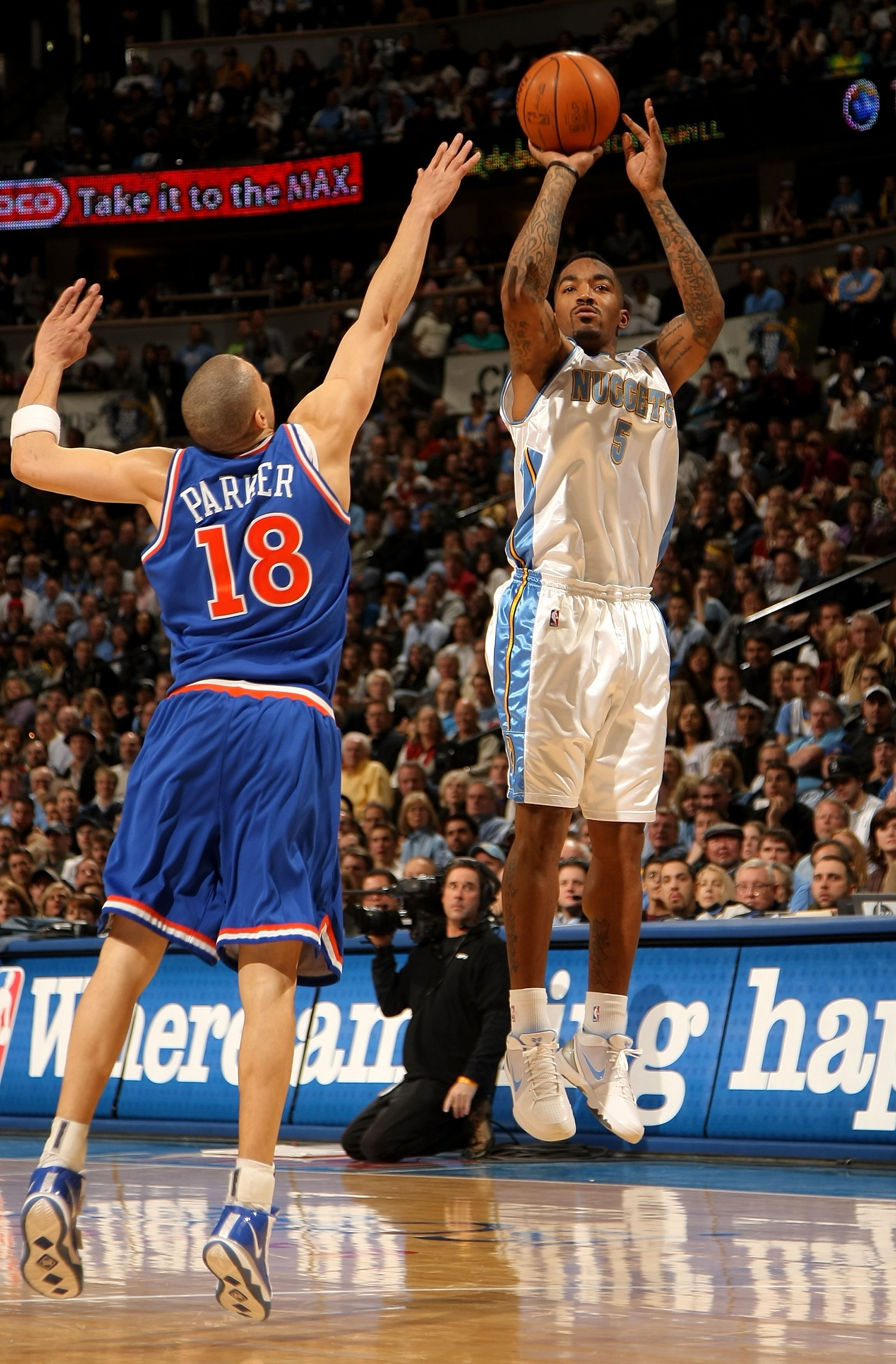 DENVER - JANUARY 08:  J.R. Smith #5 of the Denver Nuggets takes a shot over Anthony Parker #18 of the Cleveland Cavaliers during NBA action at Pepsi Center on January 8, 2010 in Denver, Colorado. The Nuggets defeated the Cavaliers 99-97. NOTE TO USER: Use