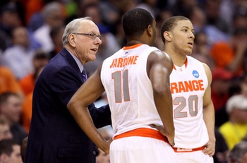 CLEVELAND, OH - MARCH 18: Head coach Jim Boeheim of the Syracuse Orange speaks to Scoop Jardine #11 and Brandon Triche #20 during the game against the Indiana State Sycamores during the second round of the 2011 NCAA men's basketball tournament at Quicken