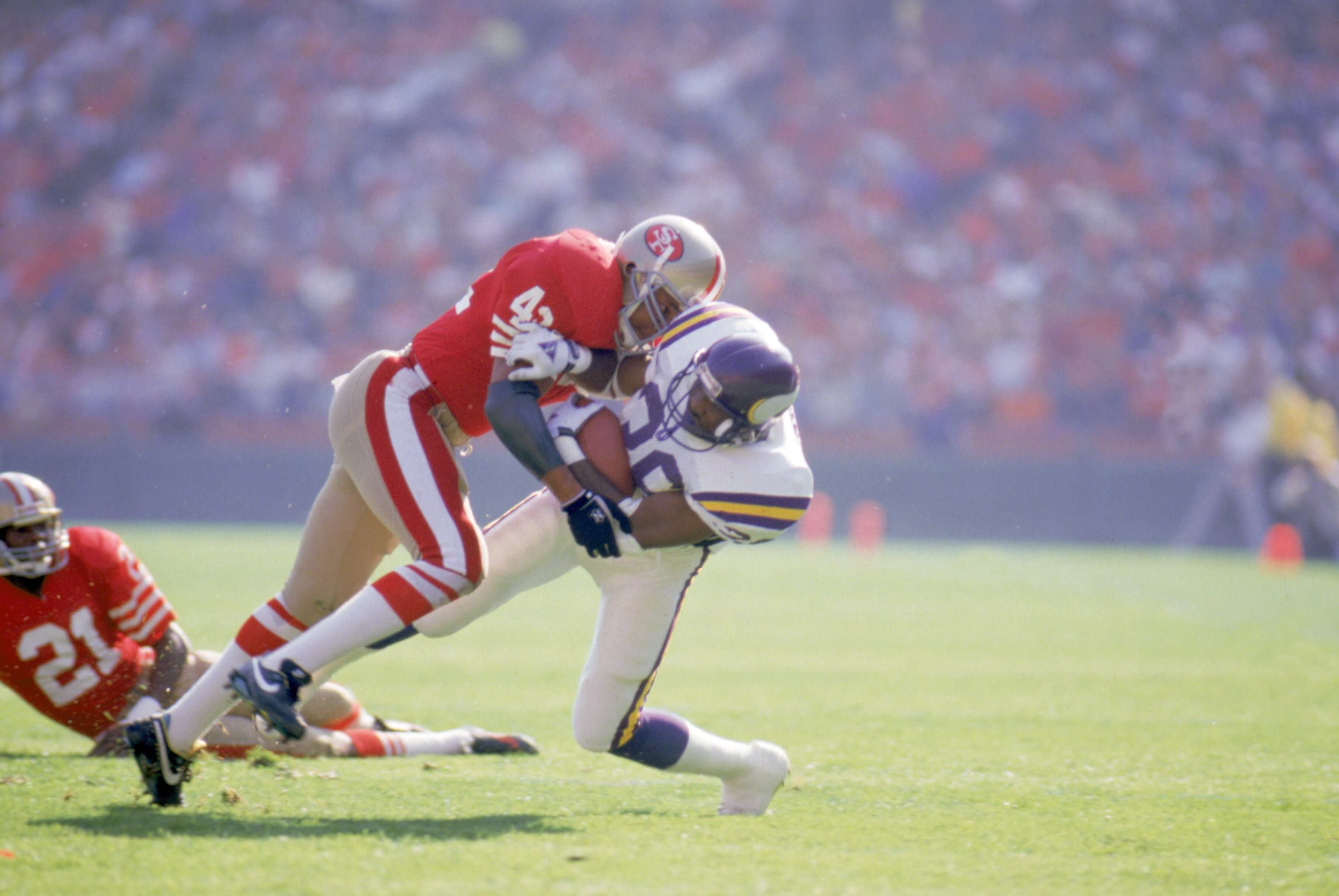 SAN FRANCISCO - OCTOBER 30:  Defenseman Ronnie Lott #42 of the San Francisco 49ers makes a tackle during a NFL game against the Minnesota Vikings at Candlestick Park on October 30, 1988 in San Francisco, California.  The Niners defeated the Vikings 24-21.