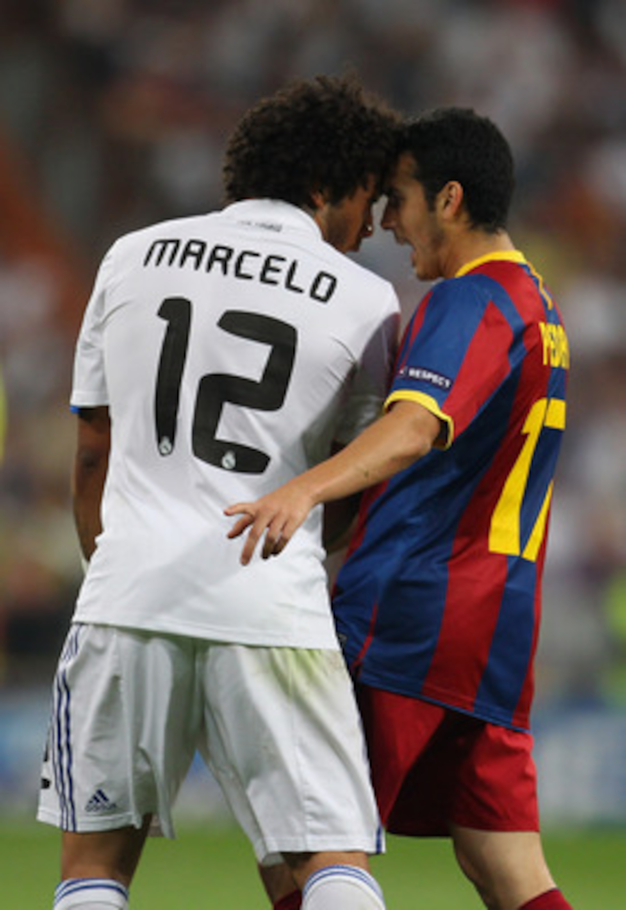 MADRID, SPAIN - APRIL 27:  Marcelo of Real Madrid and Pedro Rodriguez of Barcelona clash during the UEFA Champions League Semi Final first leg match between Real Madrid and Barcelona at Estadio Santiago Bernabeu on April 27, 2011 in Madrid, Spain.  (Photo