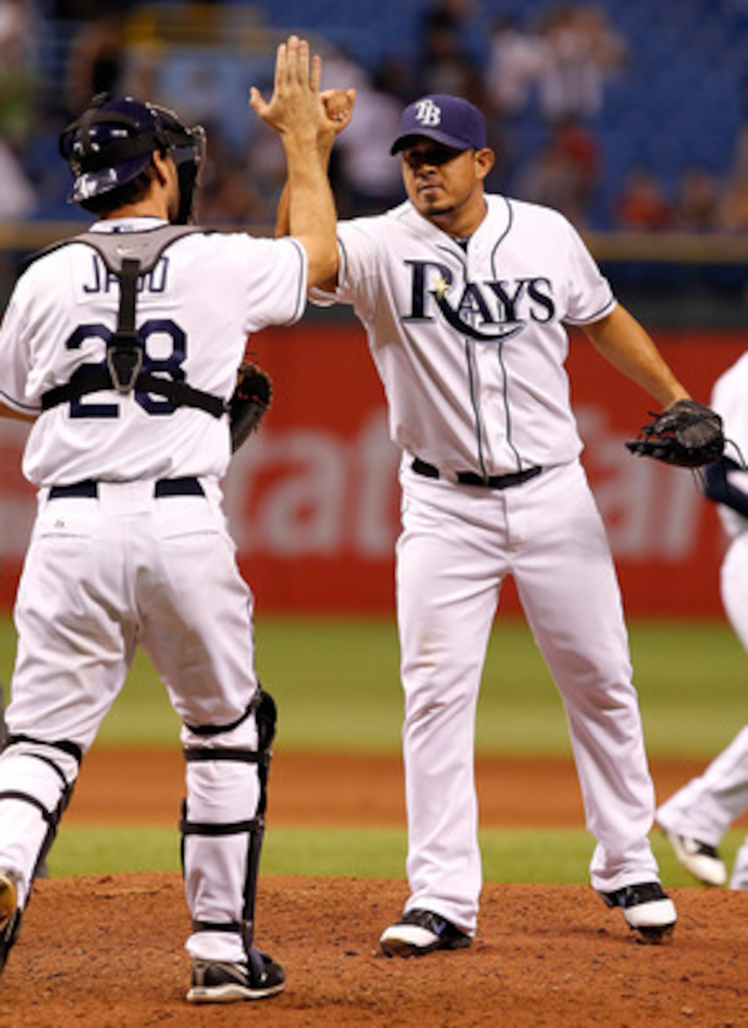 ST. PETERSBURG, FL - APRIL 18:  Pitcher Joel Peralta #62 of the Tampa Bay Rays is congratulated by catcher John Jaso #28 after getting the last three outs against the Chicago White Sox during the game at Tropicana Field on April 18, 2011 in St. Petersburg