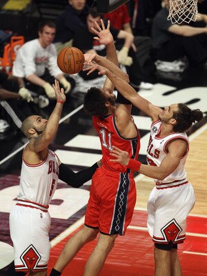CHICAGO, IL - APRIL 13: Joakim Noah #13 of the Chicago Bulls blocks a shot by Brook Lopez #11 of the New Jersey Nets as Carlos Boozer #5 reaches for the ball at United Center on April 13, 2011 in Chicago, Illinois. NOTE TO USER: User expressly acknowledge CHICAGO, IL - APRIL 13: Joakim Noah #13 of the Chicago Bulls blocks a shot by Brook Lopez #11 of the New Jersey Nets as Carlos Boozer #5 reaches for the ball at United Center on April 13, 2011 in Chicago, Illinois. NOTE TO USER: User expressly acknowledge