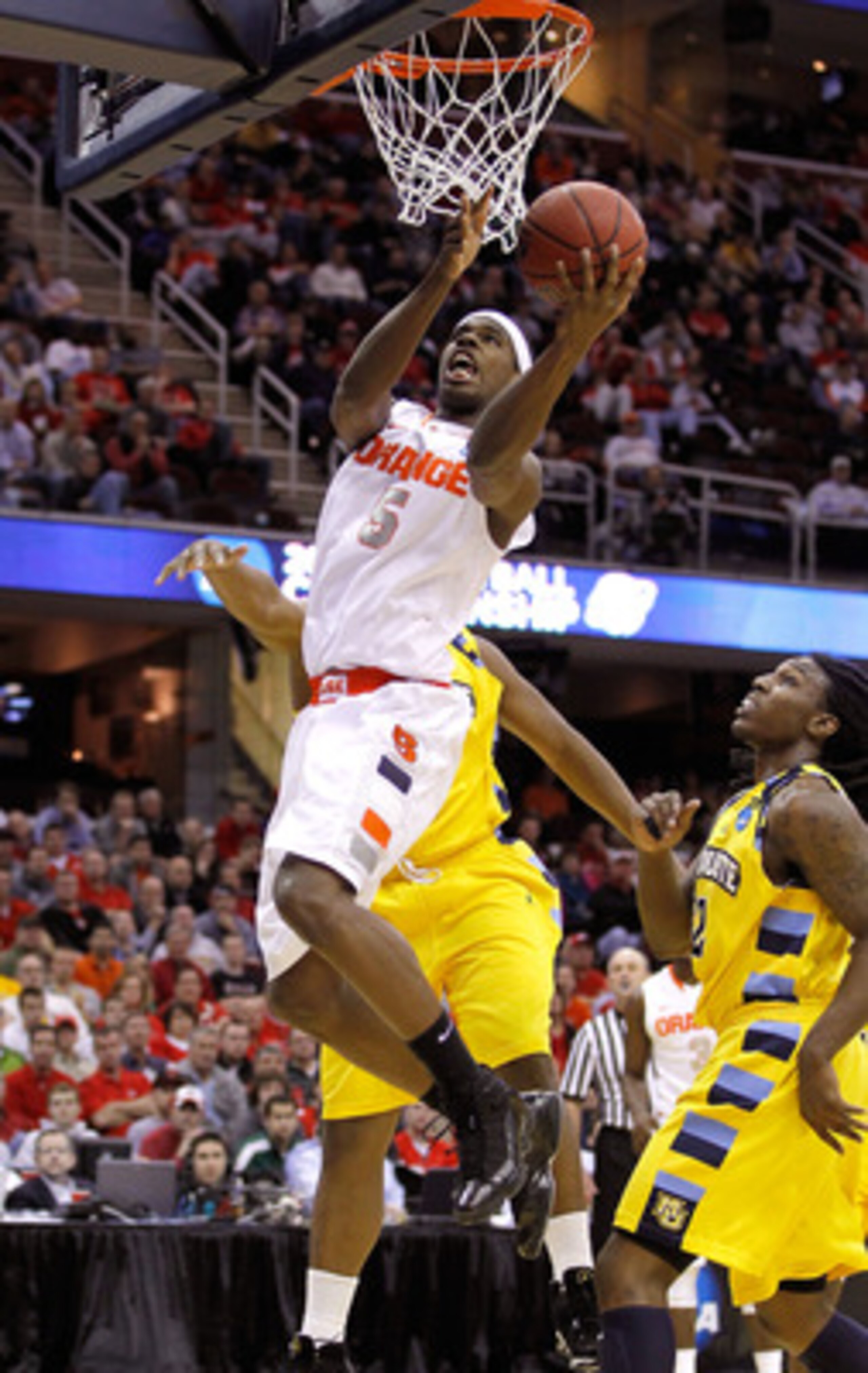 CLEVELAND, OH - MARCH 20: C.J. Fair #5 of the Syracuse Orange drives to the basket against the Marquette Golden Eagles during the third of the 2011 NCAA men's basketball tournament at Quicken Loans Arena on March 20, 2011 in Cleveland, Ohio.  (Photo by Gr