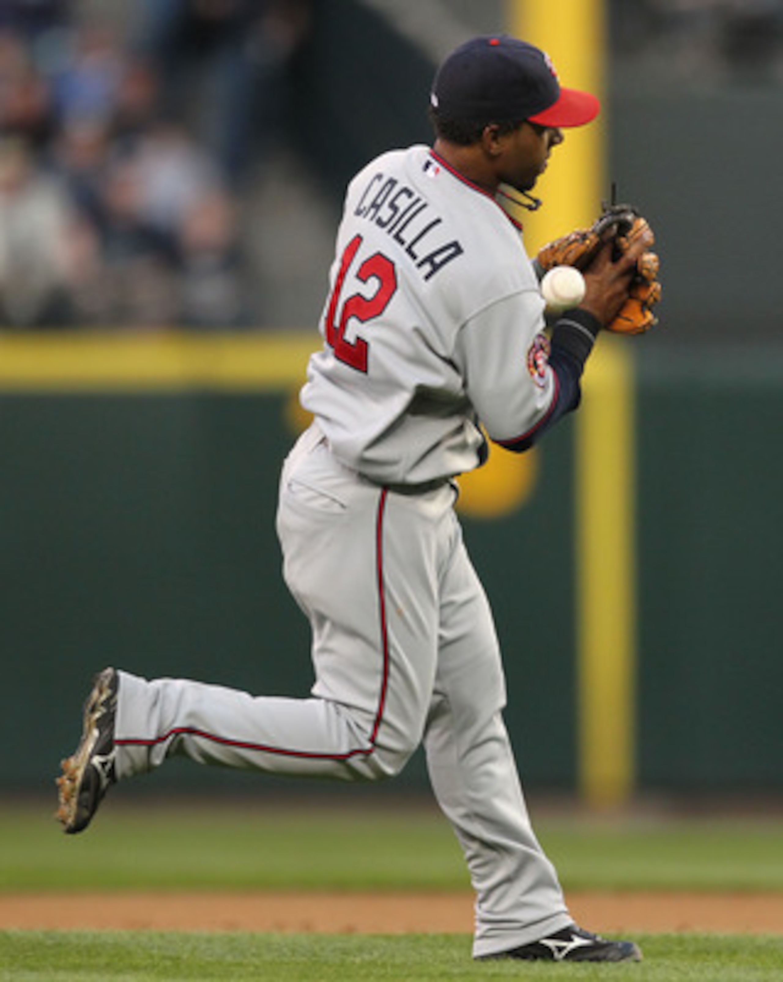 SEATTLE - AUGUST 27:  Shortstop Alexi Casilla #12 of the Minnesota Twins bobbles an infield single by Adam Moore of the Seattle Mariners at Safeco Field on August 27, 2010 in Seattle, Washington. The Twins won 6-3. (Photo by Otto Greule Jr/Getty Images)