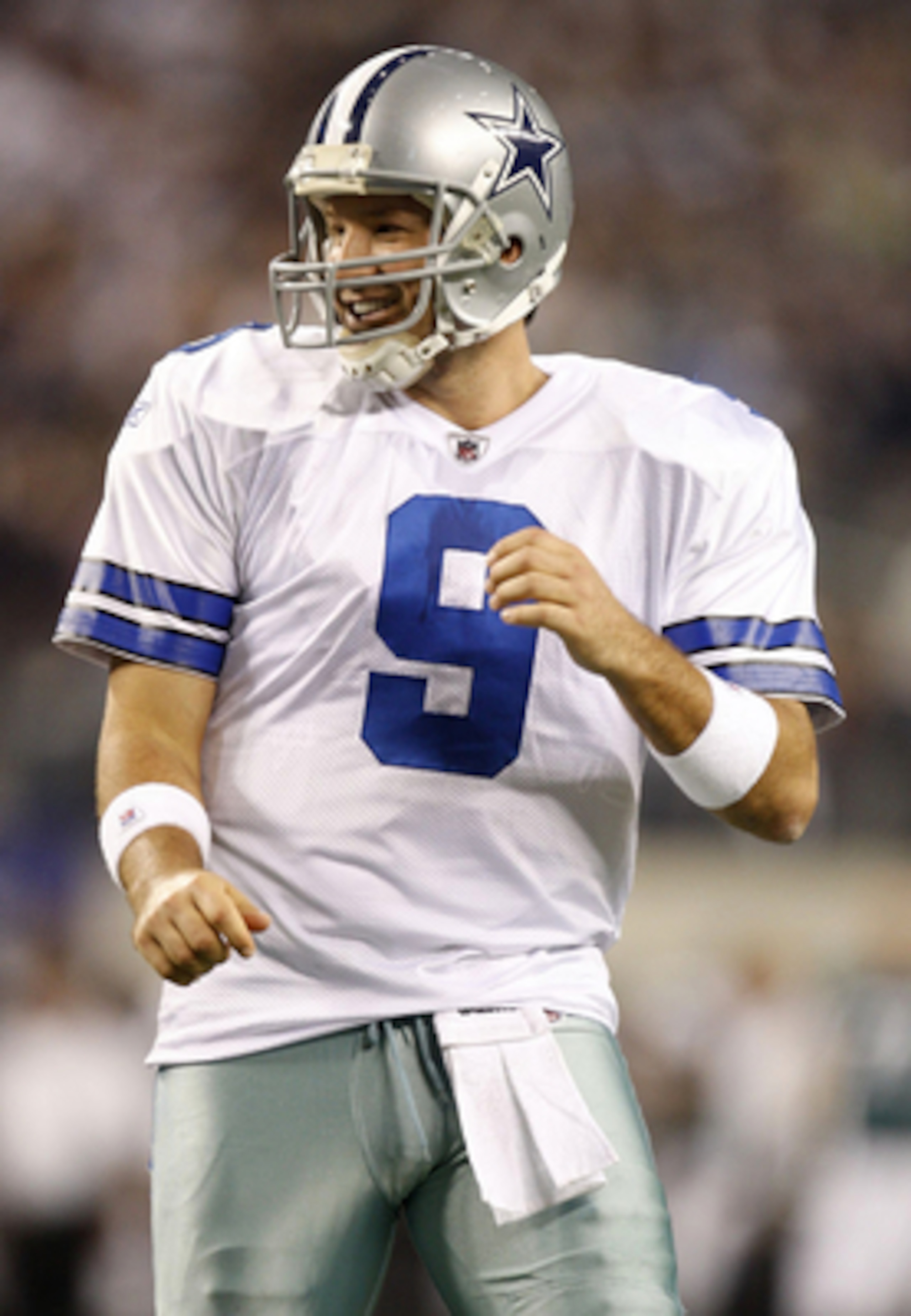 ARLINGTON, TX - JANUARY 9:  Quarterback Tony Romo #9 of the Dallas Cowboys reacts after a touchdown by wide receiver Miles Austin #19 against the Philadelphia Eagles in the first half of the 2010 NFC wild-card playoff game at Cowboys Stadium on January 9,