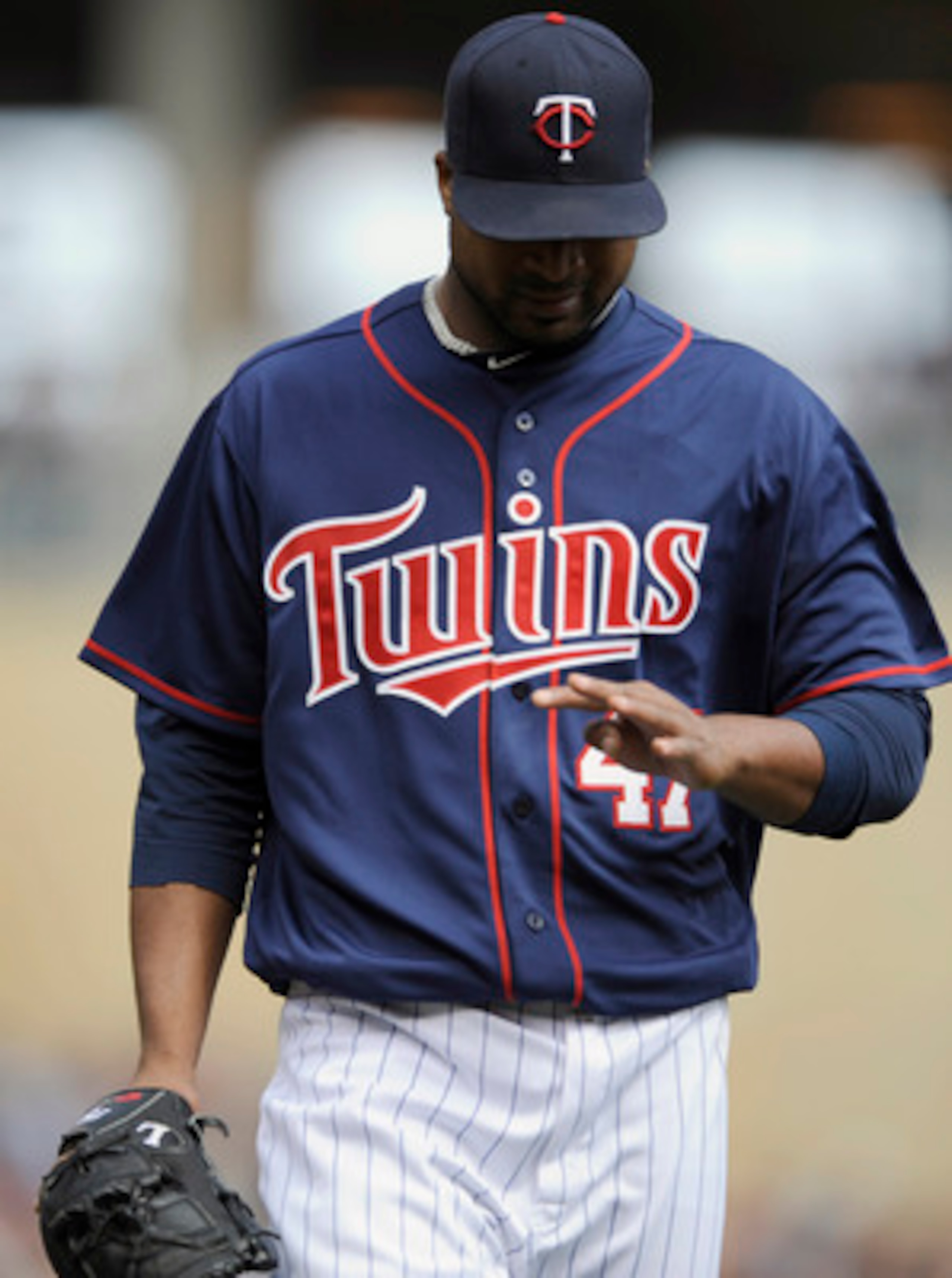 MINNEAPOLIS, MN - APRIL 13: Francisco Liriano #47 of the Minnesota Twins looks as his hand as he walks to the Twins' dugout during their game against the Kansas City Royals on April 13, 2011 at Target Field in Minneapolis, Minnesota. Royals defeated the T