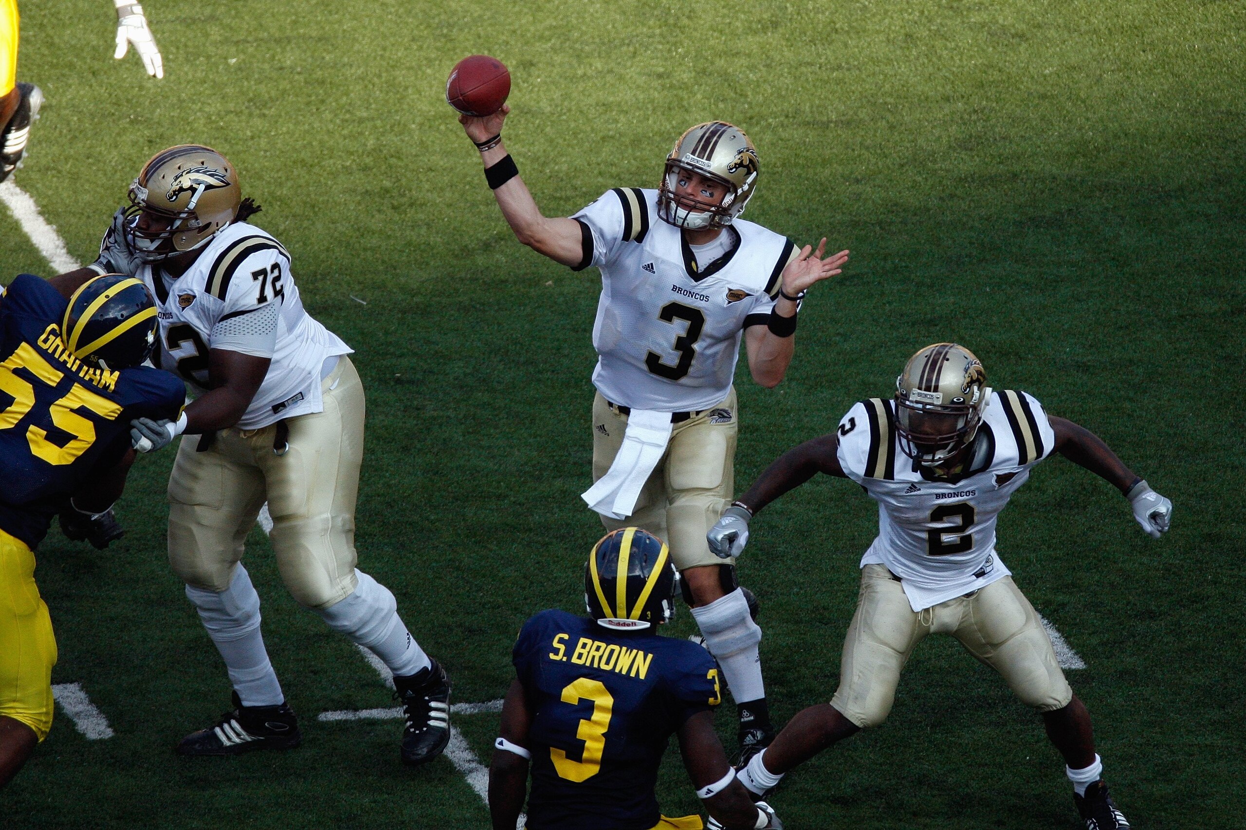 ANN ARBOR, MI - SEPTEMBER 5:  Tim Hiller #3 of the Western Michigan Broncos passes as Anthony Parker #72 and Brandon West #2 block during the game against the Michigan Wolverines on September 5, 2009 at Michigan Stadium in Ann Arbor, Michigan. (Photo by G