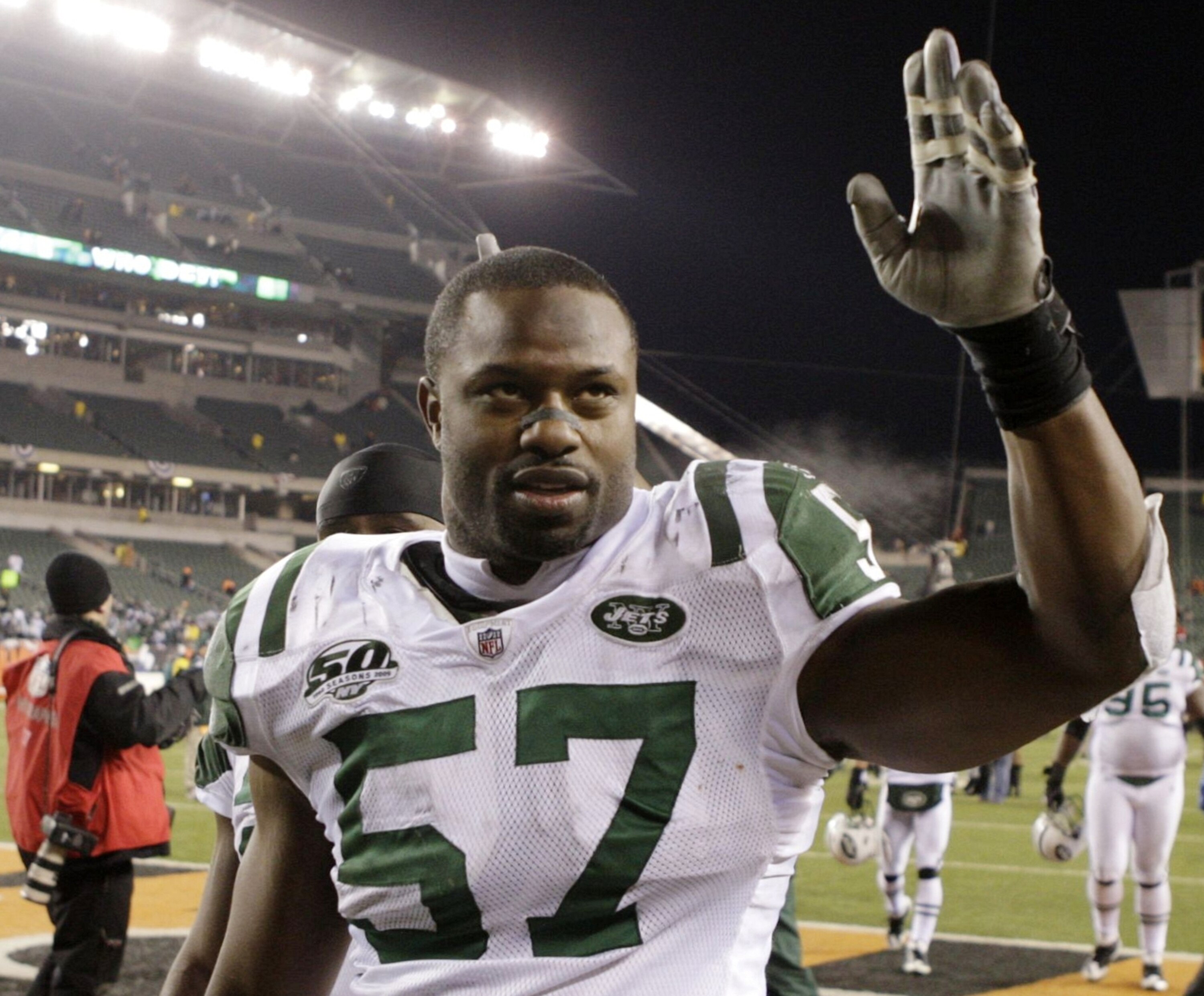 CINCINNATI - JANUARY 9:  Linebacker Bart Scott #57 of the New York Jets walks off the field after defeating the Cincinnati Bengals in the 2010 AFC wild-card playoff game at Paul Brown Stadium on January 9, 2010 in Cincinnati, Ohio. (Photo by Andy Lyons/Ge