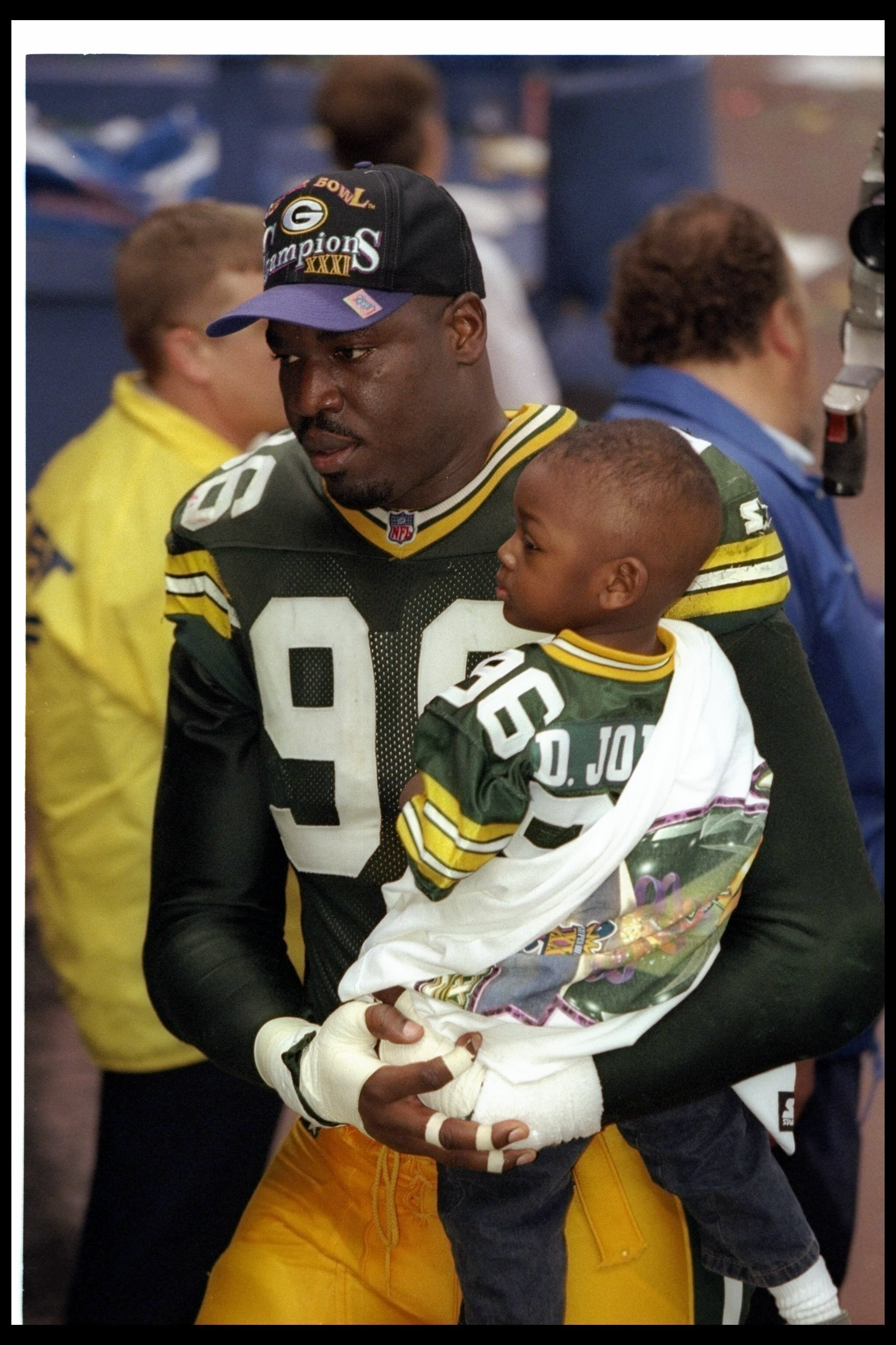 26 Jan 1997: Defensive lineman Sean Jones of the Green Bay Packers celebrates with his son after Super Bowl XXXI against the New England Patriots at the Superdome in New Orleans, Louisiana. The Packers won the game, 35-21.