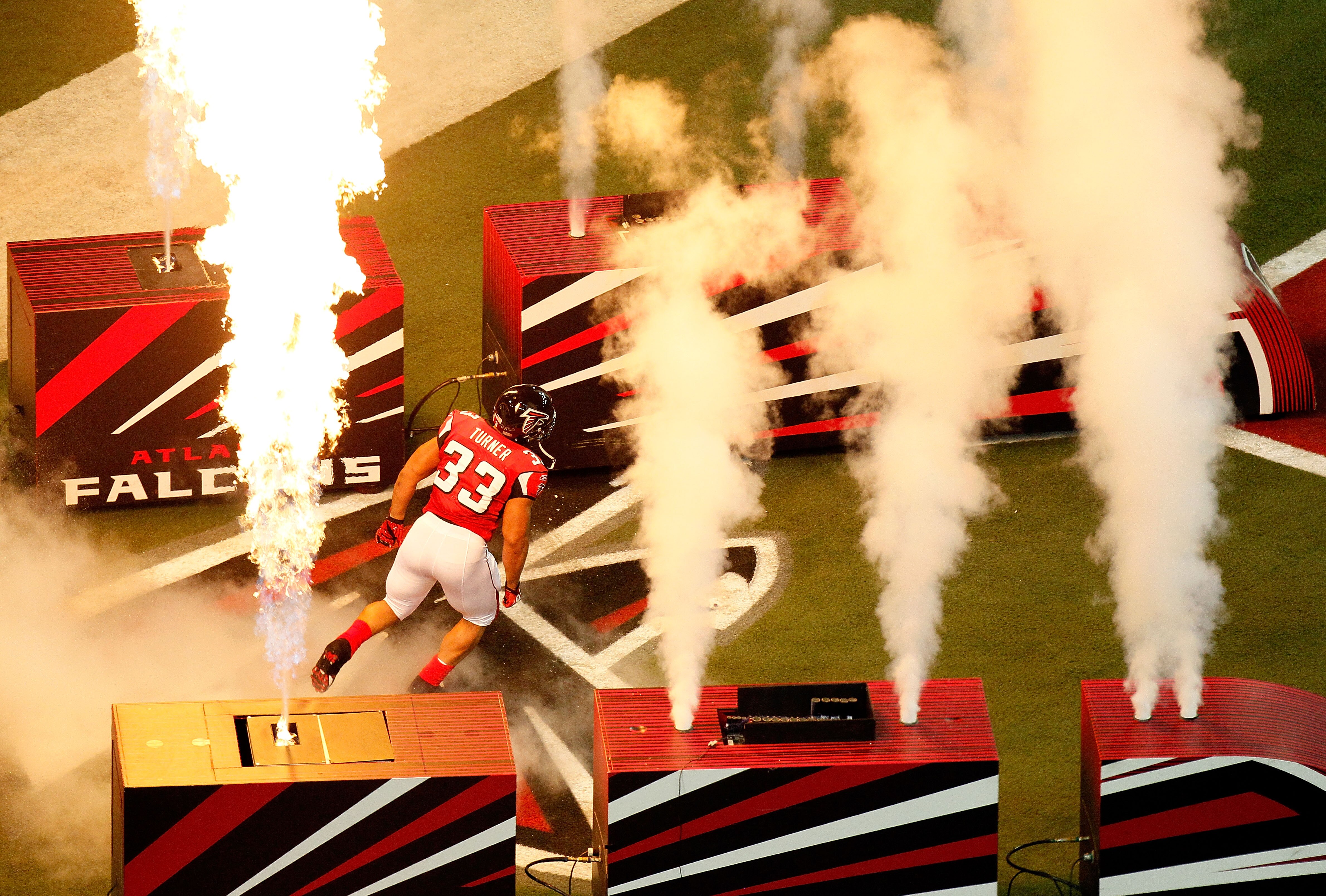 ATLANTA, GA - JANUARY 15:  Michael Turner #33 of the Atlanta Falcons runs onto the field during player introductions against the Green Bay Packers during their 2011 NFC divisional playoff game at Georgia Dome on January 15, 2011 in Atlanta, Georgia.  The