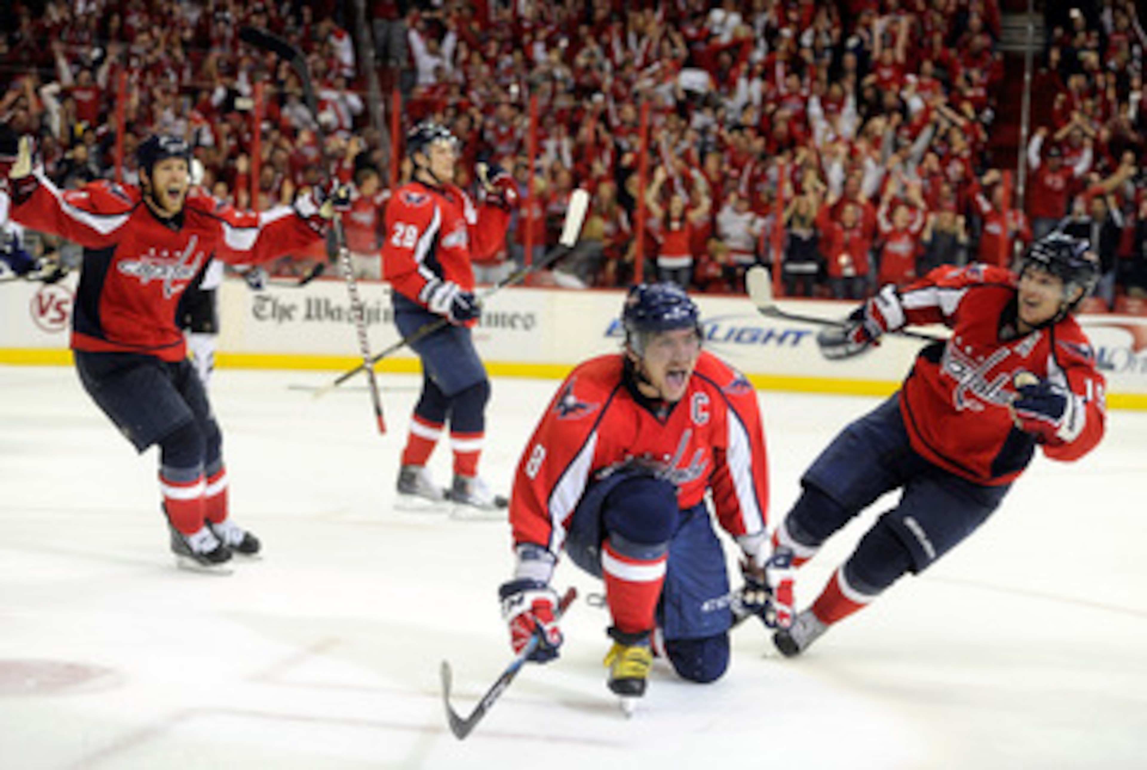 WASHINGTON, DC - MAY 01:  Alex Ovechkin #8 of the Washington Capitals celebrates with Brooks Laich #21, Alexander Semin #28, and Nicklas Backstrom #19 after scoring the tying goal in the third period against the Tampa Bay Lightning during Game Two of the