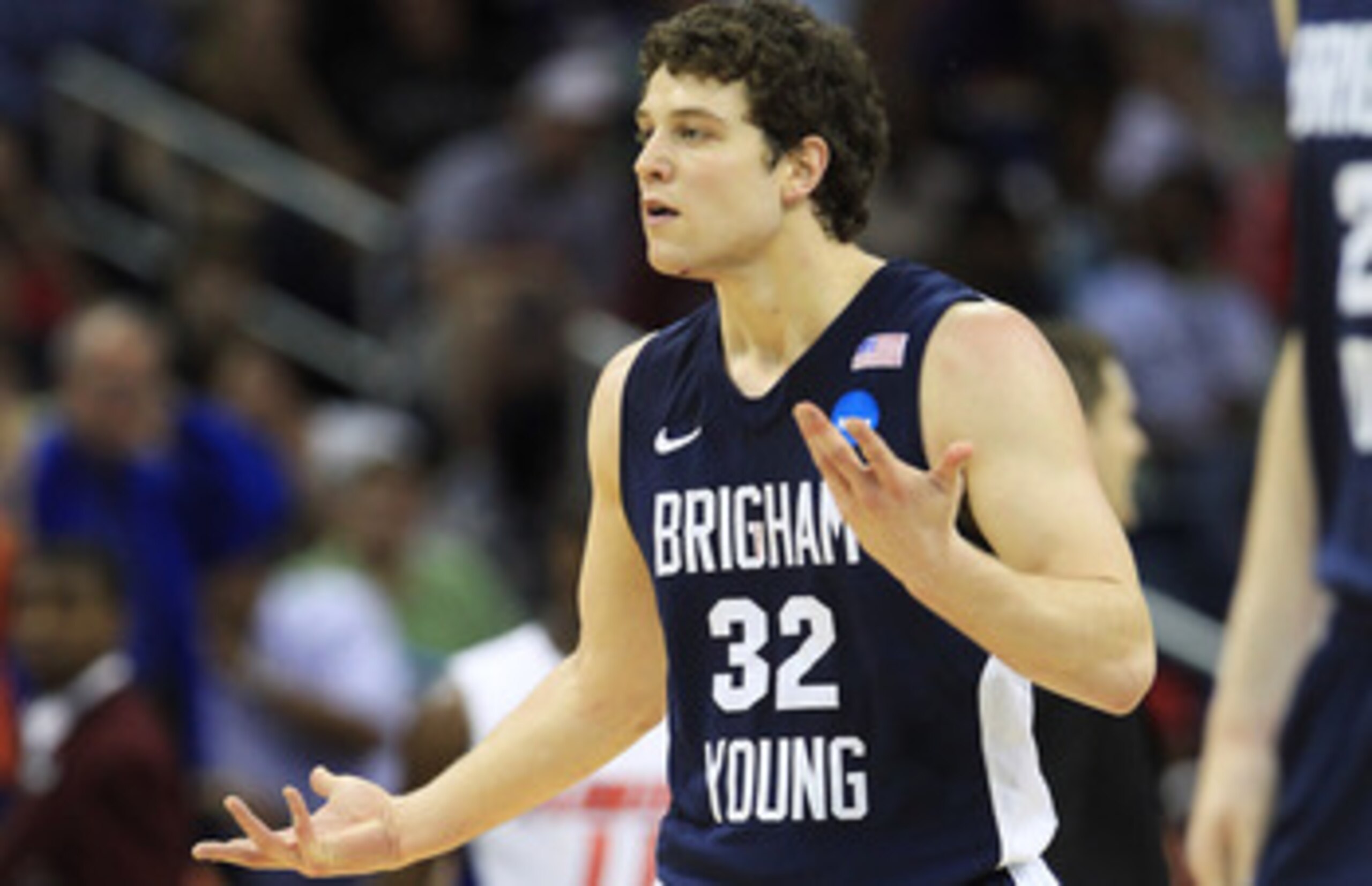 NEW ORLEANS, LA - MARCH 24:  Jimmer Fredette #32 of the Brigham Young Cougars reacts after being injured during their game against the Florida Gators in the Southeast regional of the 2011 NCAA men's basketball tournament at New Orleans Arena on March 24,