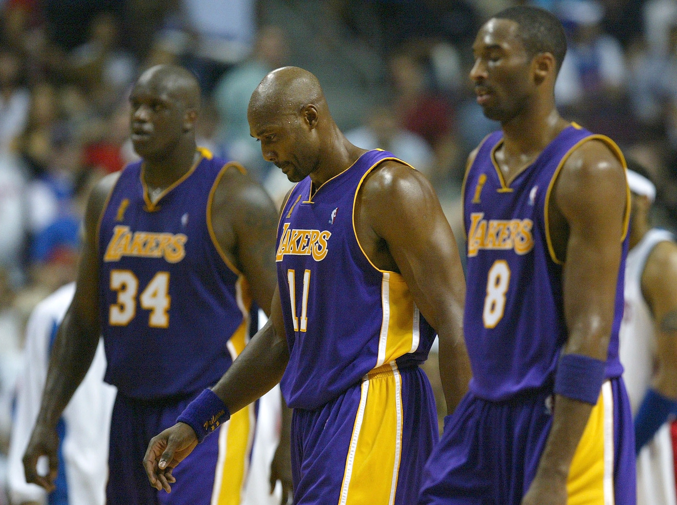 AUBURN HILLS, MI - JUNE 13:  (L-R) Shaquille O'Neal #34, Karl Malone #11 and Kobe Bryant #8 of the Los Angeles Lakers walk off the court in Game Four of the 2004 NBA Finals against the Detroit Pistons on June 13, 2004 at The Palace of Auburn Hills in Aubu