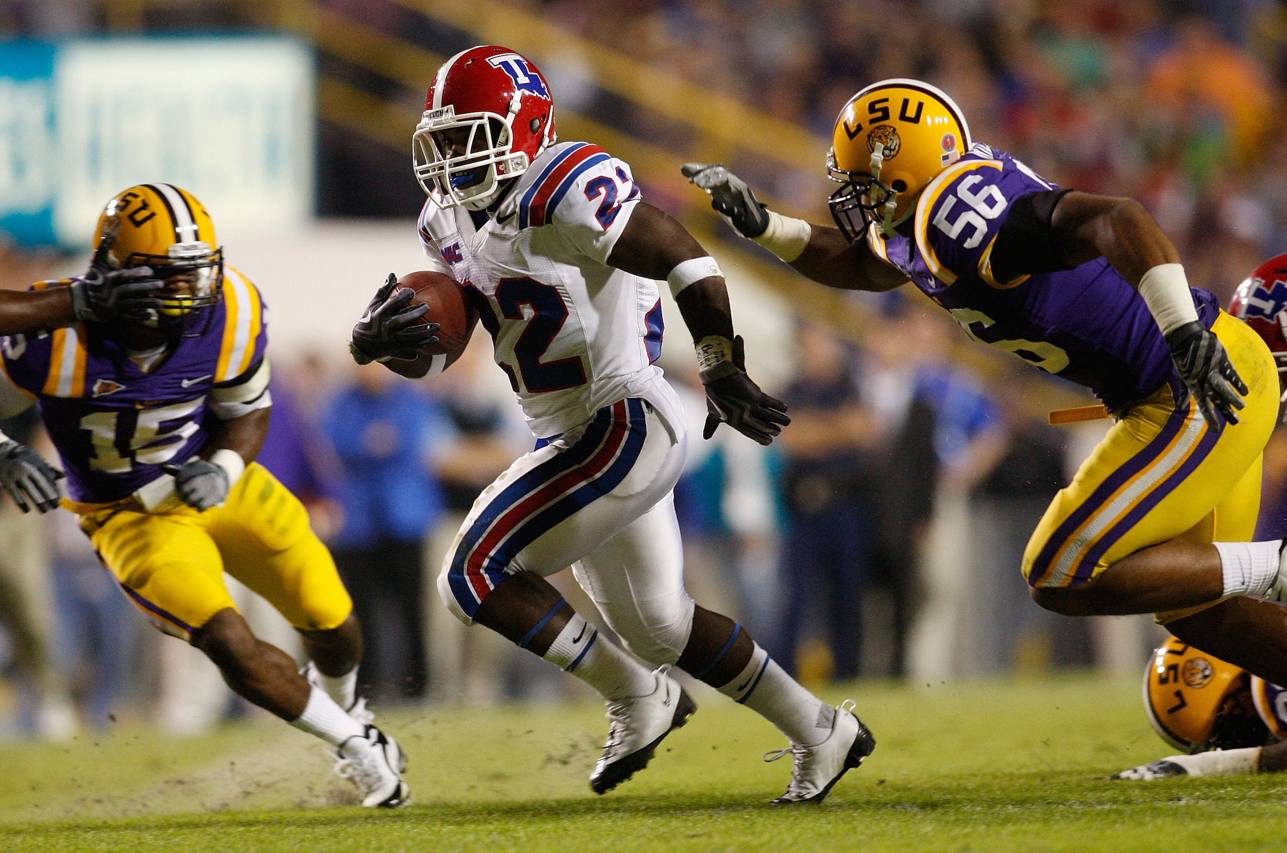 BATON ROUGE, LA - NOVEMBER 14:  Tyrone Duplessis #22 of the Louisiana Tech Bulldogs is brought down by Perry Riley #56 of the LSU Tigers at Tiger Stadium on November 14, 2009 in Baton Rouge, Louisiana.  (Photo by Chris Graythen/Getty Images)