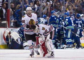 VANCOUVER, CANADA - APRIL 26: Troy Brouwer #22 consoles goalie Corey Crawford #50 of the Chicago Blackhawks after losing 2-1 in overtime to the Vancouver Canucks in Game Seven of the Western Conference Quarterfinals during the 2011 NHL Stanley Cup Playoff