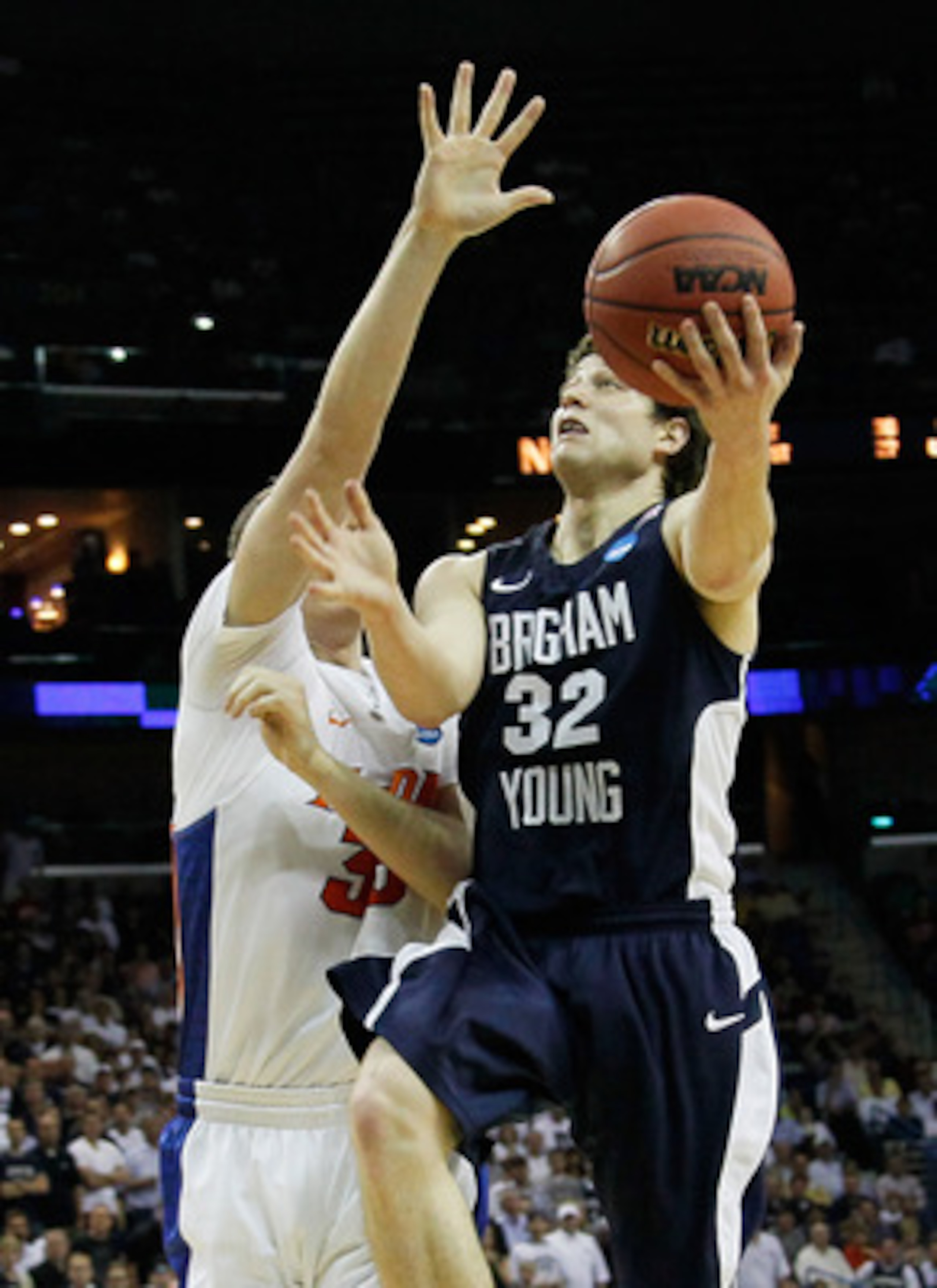 NEW ORLEANS, LA - MARCH 24: Jimmer Fredette #32 of the Brigham Young Cougars shoots over Erik Murphy #33 of the Florida Gators during the Southeast regional of the 2011 NCAA men's basketball tournament at New Orleans Arena on March 24, 2011 in New Orlean NEW ORLEANS, LA - MARCH 24: Jimmer Fredette #32 of the Brigham Young Cougars shoots over Erik Murphy #33 of the Florida Gators during the Southeast regional of the 2011 NCAA men's basketball tournament at New Orleans Arena on March 24, 2011 in New Orlean