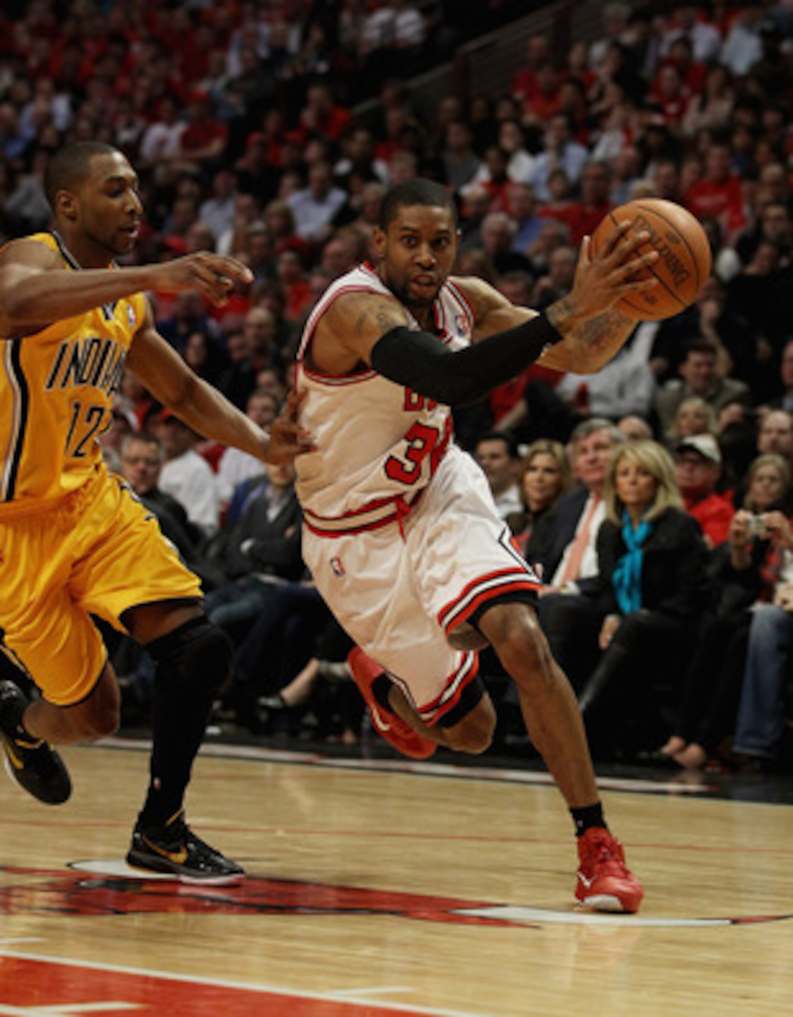 CHICAGO, IL - APRIL 26: C.J. Watson #32 of the Chicago Bulls drives past A.J. Price #12 of the Indiana Pacers in Game Five of the Eastern Conference Quarterfinals in the 2011 NBA Playoffs at the United Center on April 26, 2011 in Chicago, Illinois. The Bu