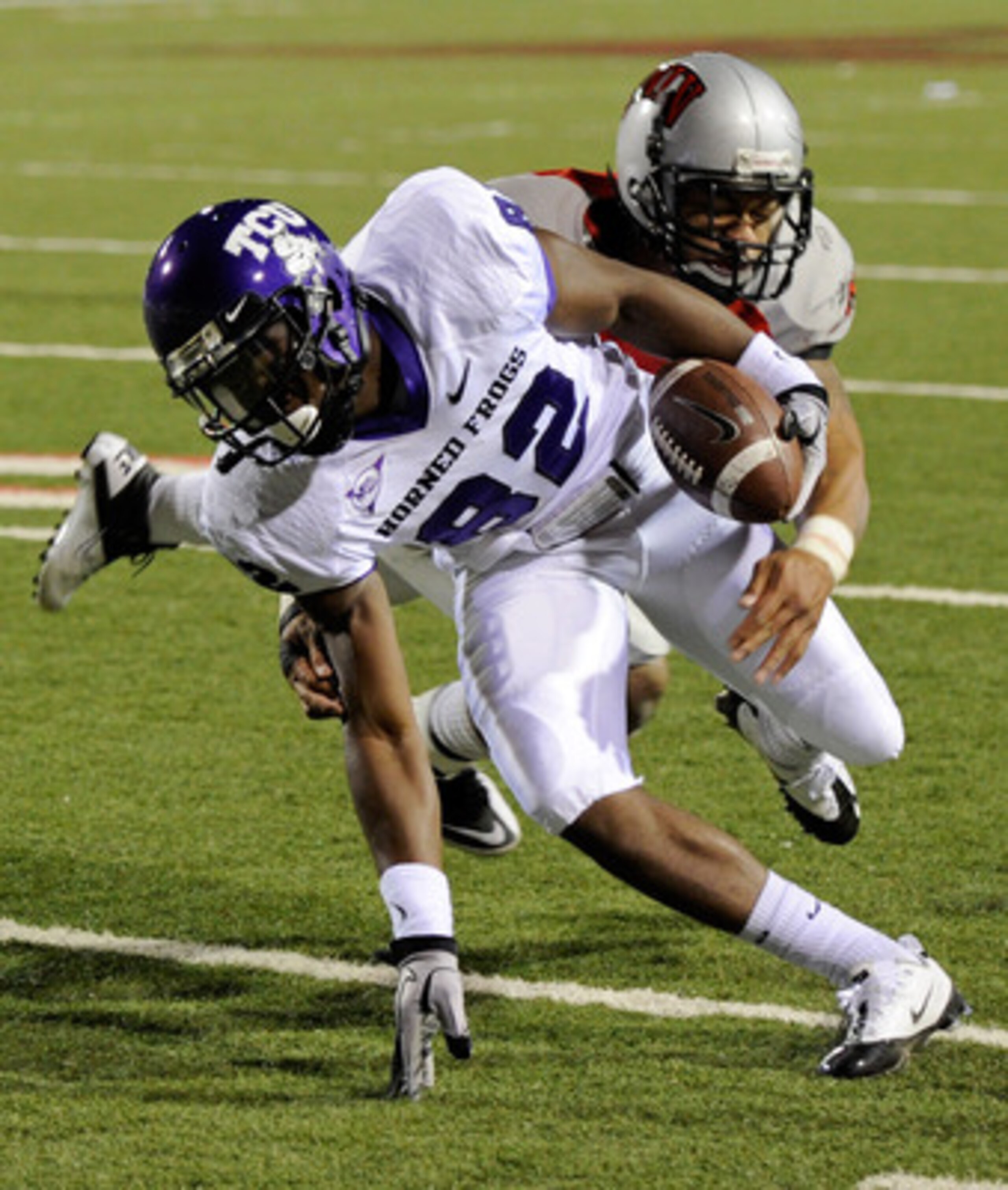 LAS VEGAS - OCTOBER 30: Josh Boyce #82 of the Texas Christian University Horned Frogs runs for yardage after a reception against Starr Fuimaono #24 of the UNLV Rebels during the second quarter of their game at Sam Boyd Stadium October 30, 2010 in Las Veg LAS VEGAS - OCTOBER 30: Josh Boyce #82 of the Texas Christian University Horned Frogs runs for yardage after a reception against Starr Fuimaono #24 of the UNLV Rebels during the second quarter of their game at Sam Boyd Stadium October 30, 2010 in Las Veg