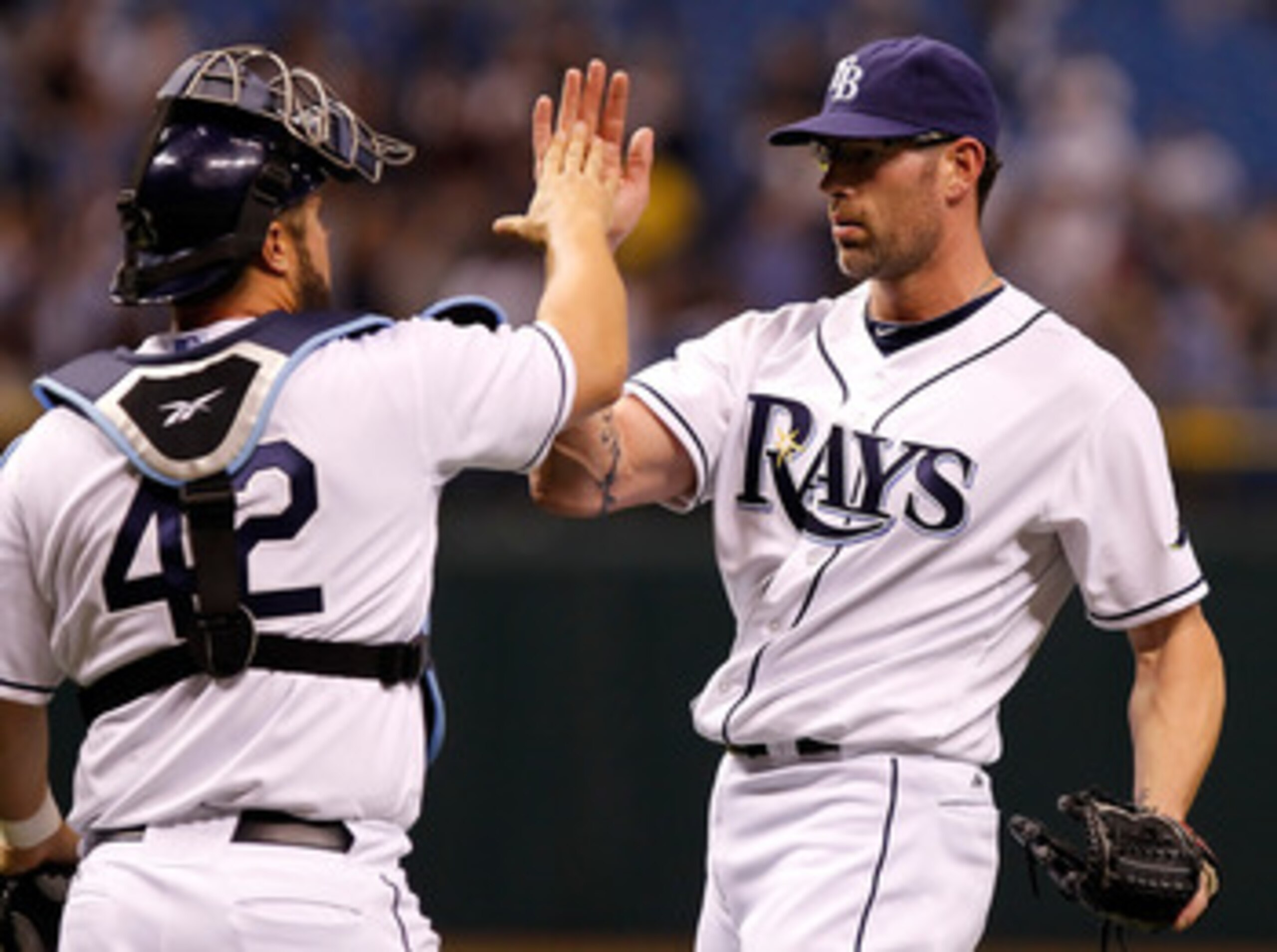 ST. PETERSBURG, FL - APRIL 15:  Pitcher Kyle Farnsworth #43 of the Tampa Bay Rays celebrates the last out with catcher Kelly Shoppach #10 during a game against the Minnesota Twins at Tropicana Field on April 15, 2011 in St. Petersburg, Florida.  (Photo by