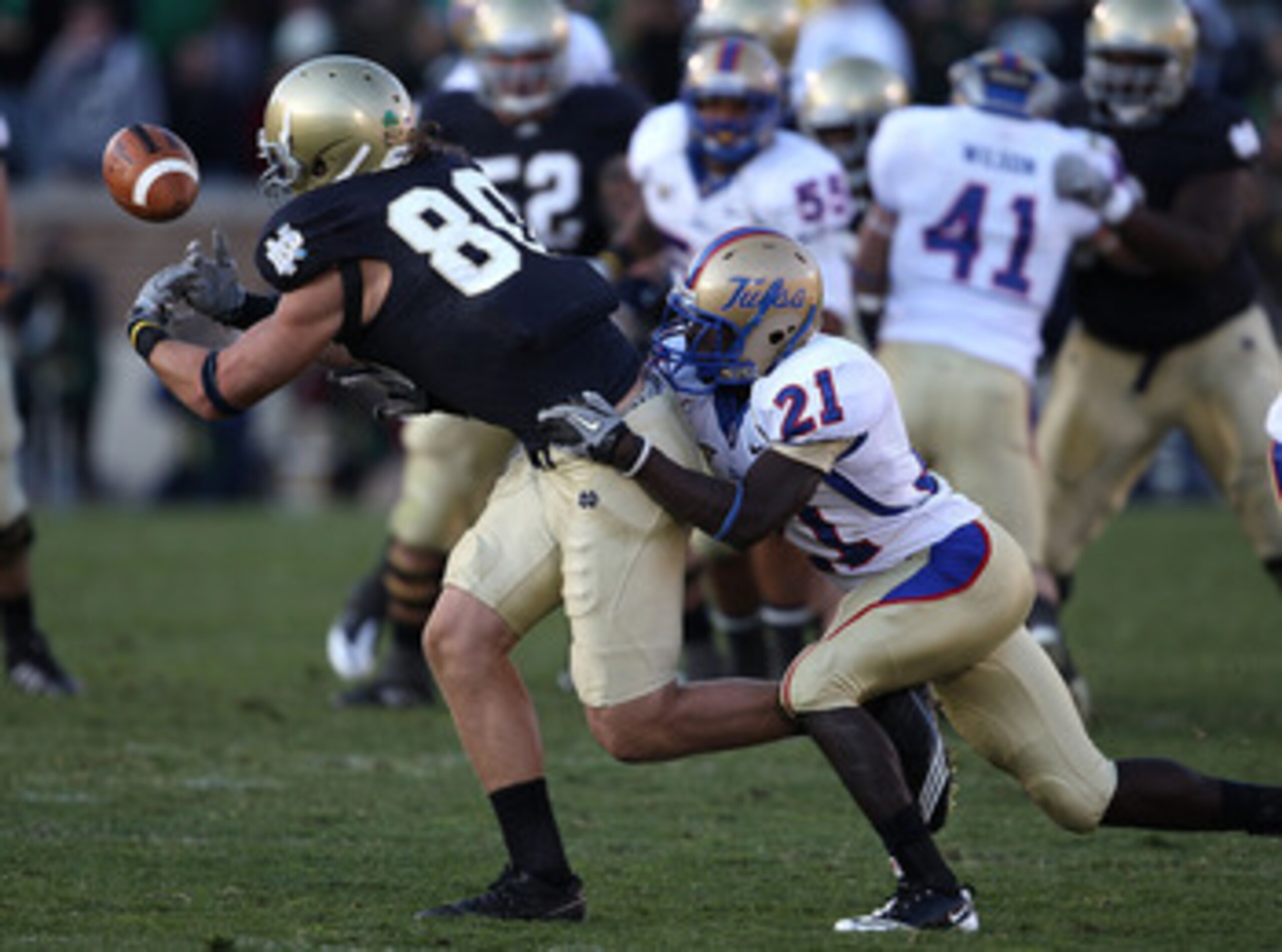 SOUTH BEND, IN - OCTOBER 30: Tyler Eifert #80 of the Notre Dame Fighting Irish drops a pass as he is hit by John Flanders #21 of the Tulsa Golden Hurricane at Notre Dame Stadium on October 30, 2010 in South Bend, Indiana. Tulsa defeated Notre Dame 28-27. SOUTH BEND, IN - OCTOBER 30: Tyler Eifert #80 of the Notre Dame Fighting Irish drops a pass as he is hit by John Flanders #21 of the Tulsa Golden Hurricane at Notre Dame Stadium on October 30, 2010 in South Bend, Indiana. Tulsa defeated Notre Dame 28-27.