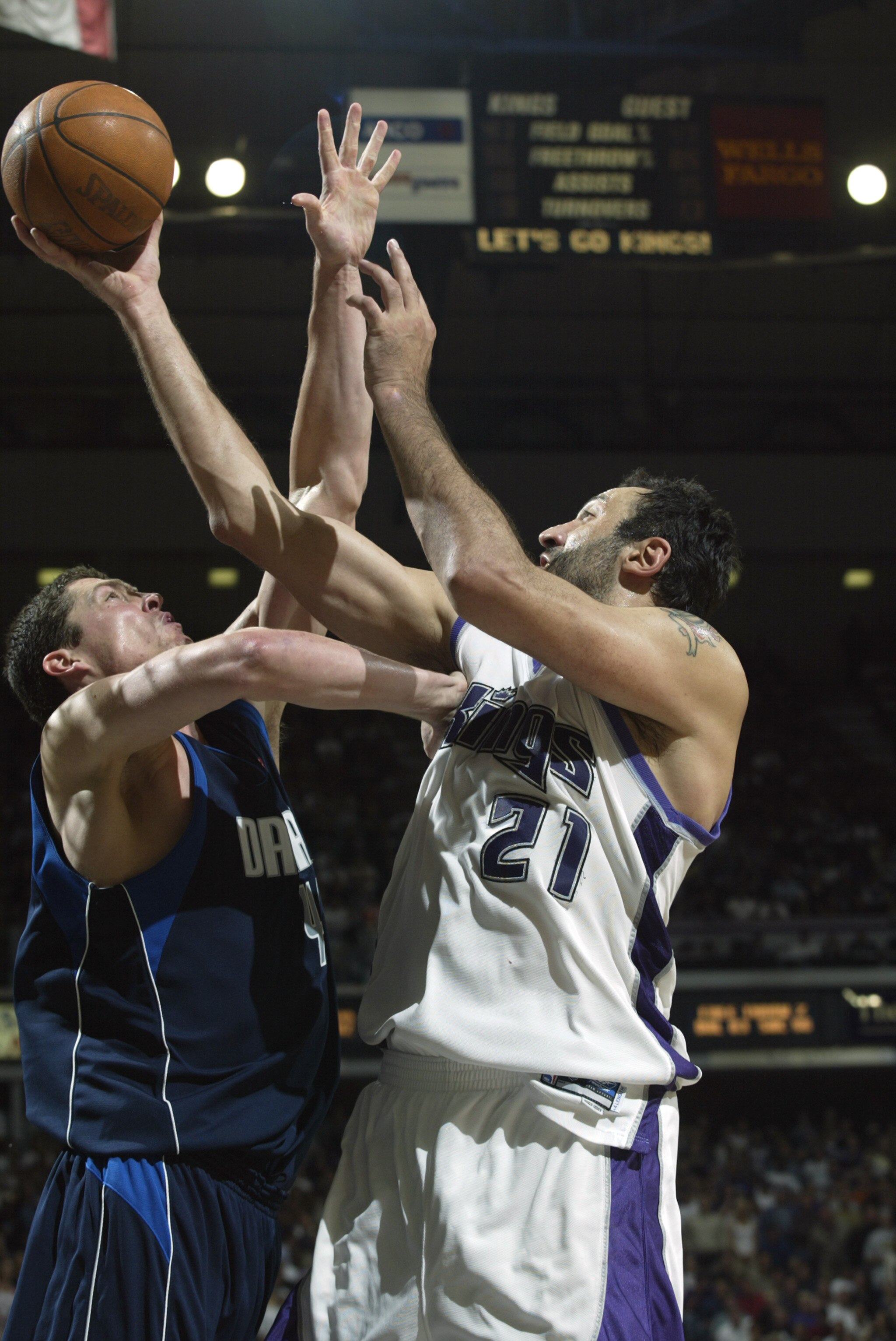SACRAMENTO, CA - MAY 15:  Vlade Divac #21 of the Sacramento Kings shoots a layup against Raef LaFrentz #45 of the Dallas Mavericks in Game six of the Western Conference Semifinals during the 2003 NBA Playoffs at Arco Arena on May 15, 2003 in Sacramento, C