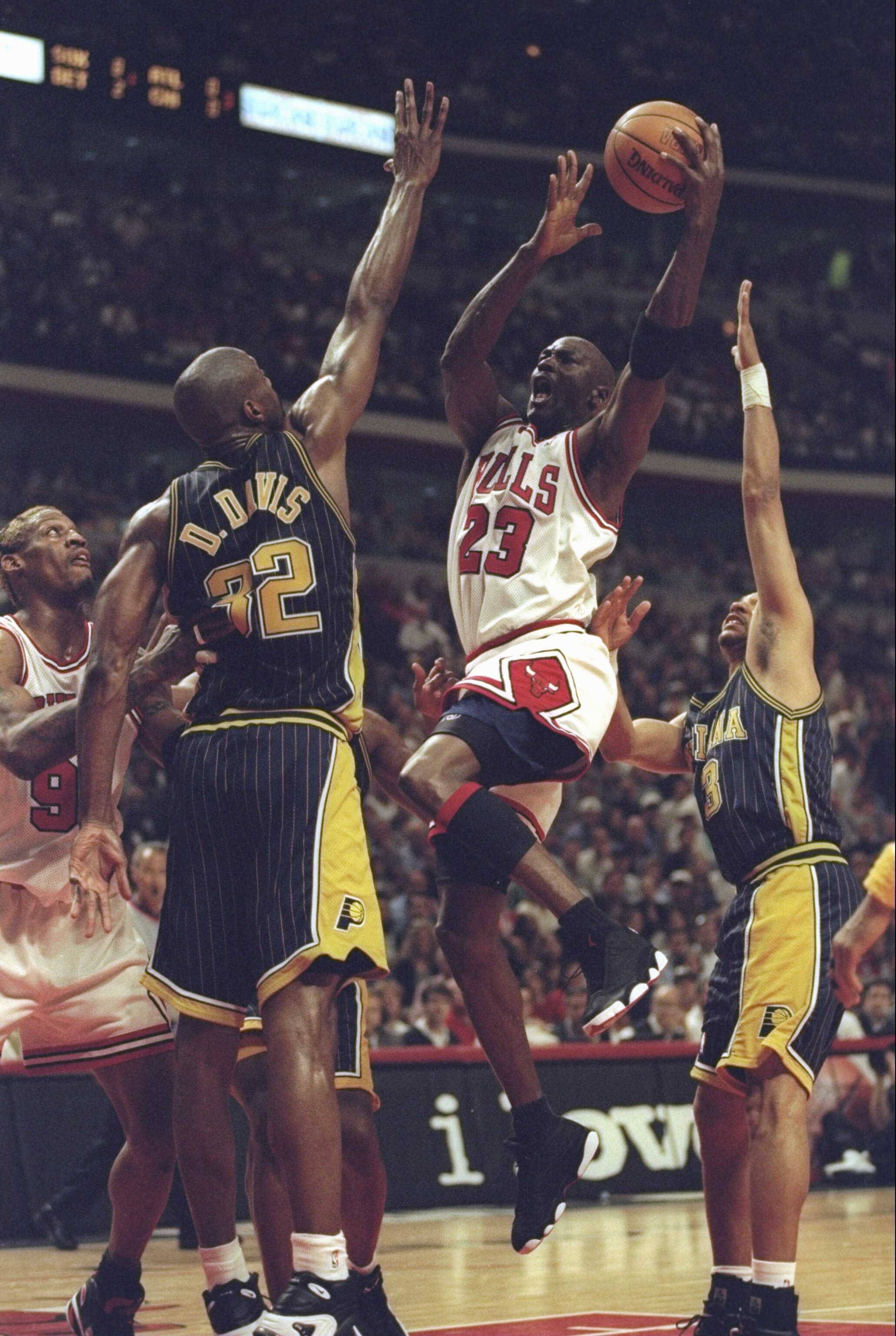 31 May 1998: Michael Jordan #23 of the Chicago Bulls drives to the basket over Dale Davis #32 of the Indiana Pacers during game seven of the Eastern Conference Finals at the United Center in Chicago, Illinois. The Bulls defeated the Pacers 88-83.
