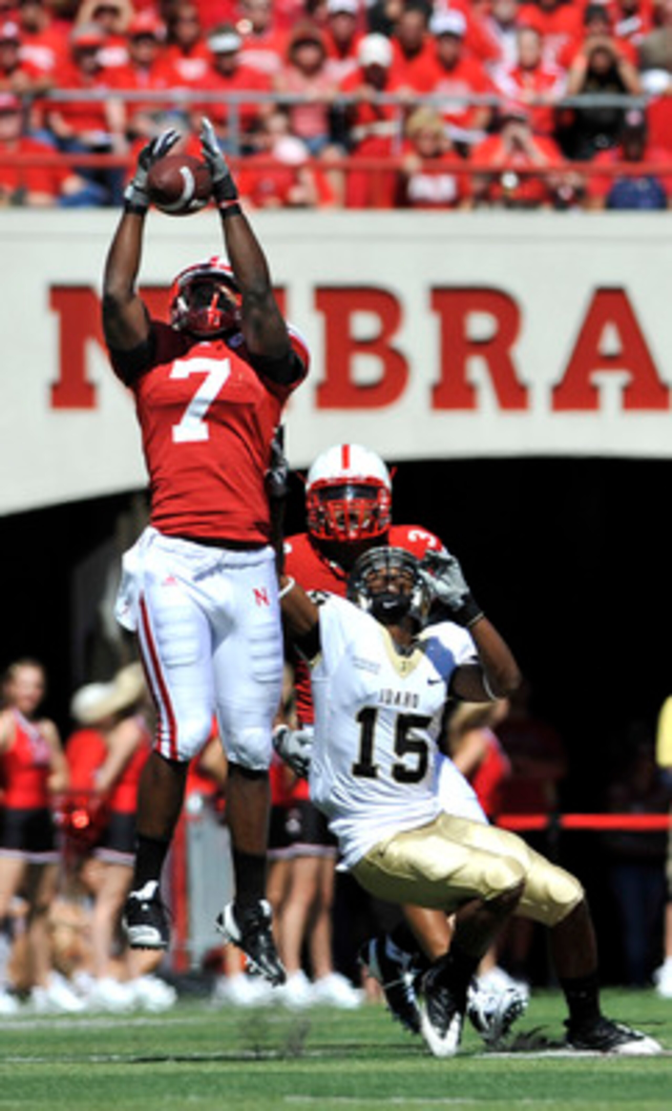 LINCOLN, NEBRASKA - SEPTEMBER 11: Nebraska Cornhuskers defensive back DeJon Gomes #7 and safety Rickey Thenarse #3 knock a pass away from Idaho Vandals wide receiver Marsel Posey #15 during first half action of their game at Memorial Stadium on September