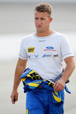 RICHMOND, VA - APRIL 29:  A.J. Allmendinger, driver of the #43 Nautica Ford, walks on pit road during qualifying for the NASCAR Sprint Cup Series Crown Royal Presents The Matthew & Daniel Hansen 400 at Richmond International Raceway on April 29, 2011 in R