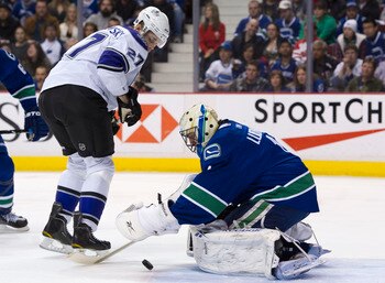 VANCOUVER, CANADA - MARCH 31: Goalie Roberto Luongo #1 of the Vancouver Canucks covers up the puck before Alexei Ponikarovsky #27 of the Los Angeles Kings can get his stick on it during the first period in NHL action on March 31, 2011 at Rogers Arena in V
