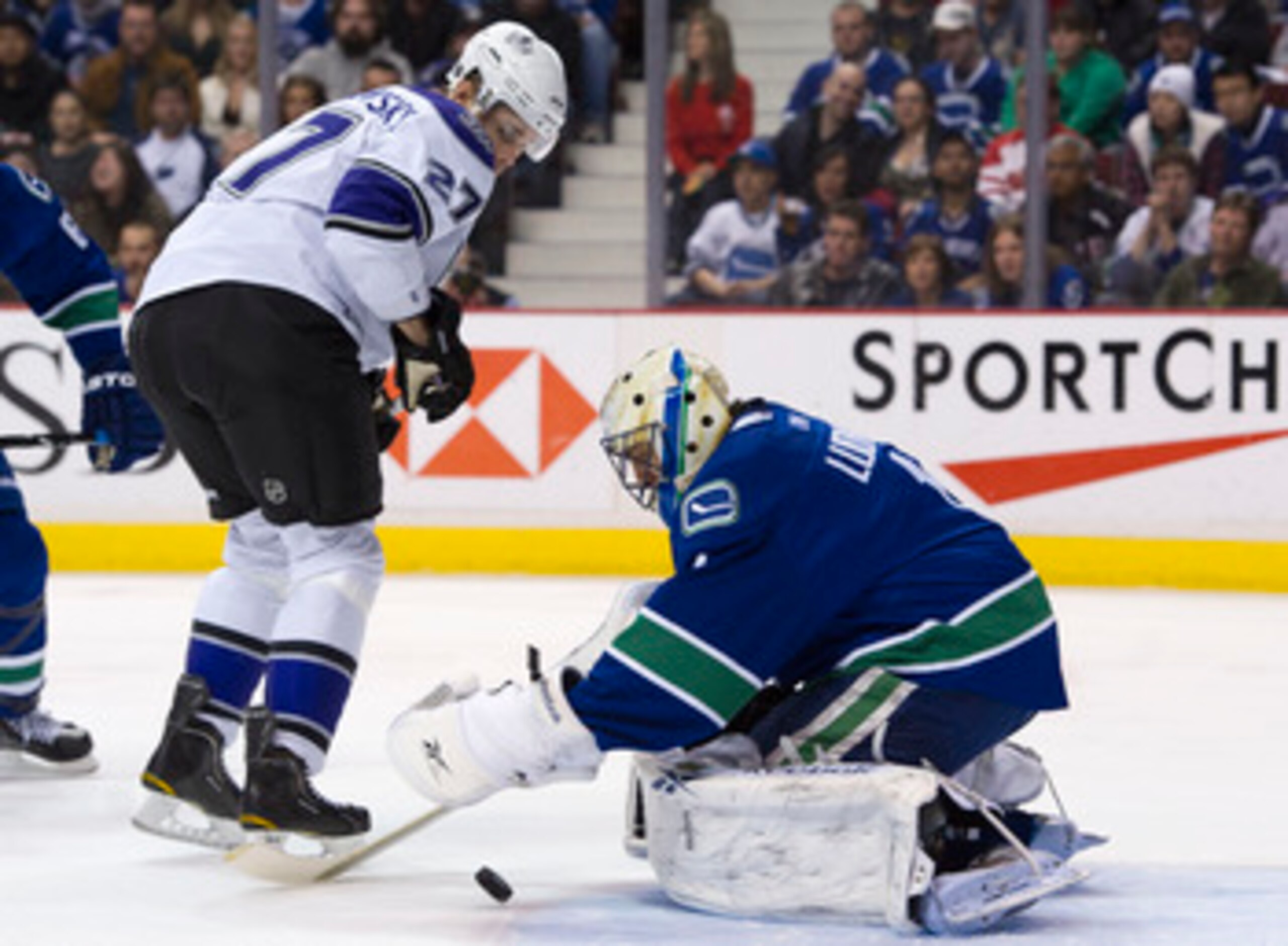 VANCOUVER, CANADA - MARCH 31: Goalie Roberto Luongo #1 of the Vancouver Canucks covers up the puck before Alexei Ponikarovsky #27 of the Los Angeles Kings can get his stick on it during the first period in NHL action on March 31, 2011 at Rogers Arena in V