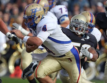 SOUTH BEND, IN - OCTOBER 30: G.J. Kinne #4 of the Tulsa Golden Hurricane is tackled by Brian Smith #58 of the Notre Dame Fighting Irish rushes at Notre Dame Stadium on October 30, 2010 in South Bend, Indiana. Tulsa defeated Notre Dame 28-27. (Photo by Jon