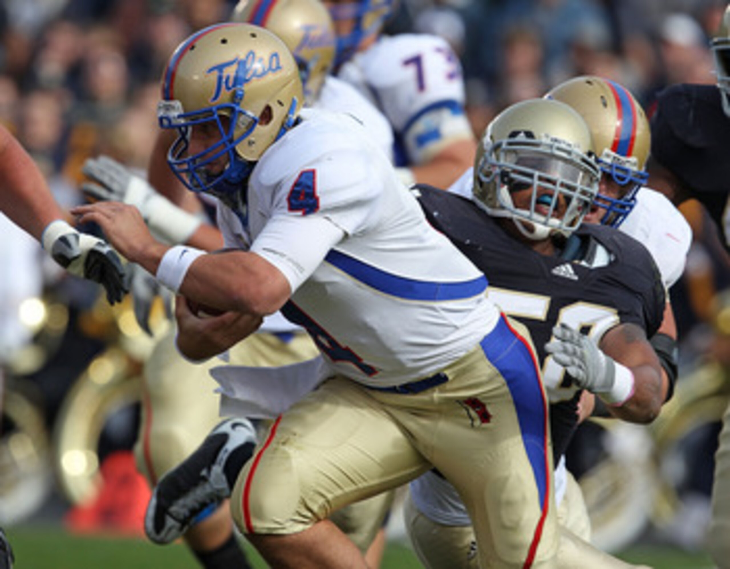 SOUTH BEND, IN - OCTOBER 30: G.J. Kinne #4 of the Tulsa Golden Hurricane is tackled by Brian Smith #58 of the Notre Dame Fighting Irish rushes at Notre Dame Stadium on October 30, 2010 in South Bend, Indiana. Tulsa defeated Notre Dame 28-27. (Photo by Jon