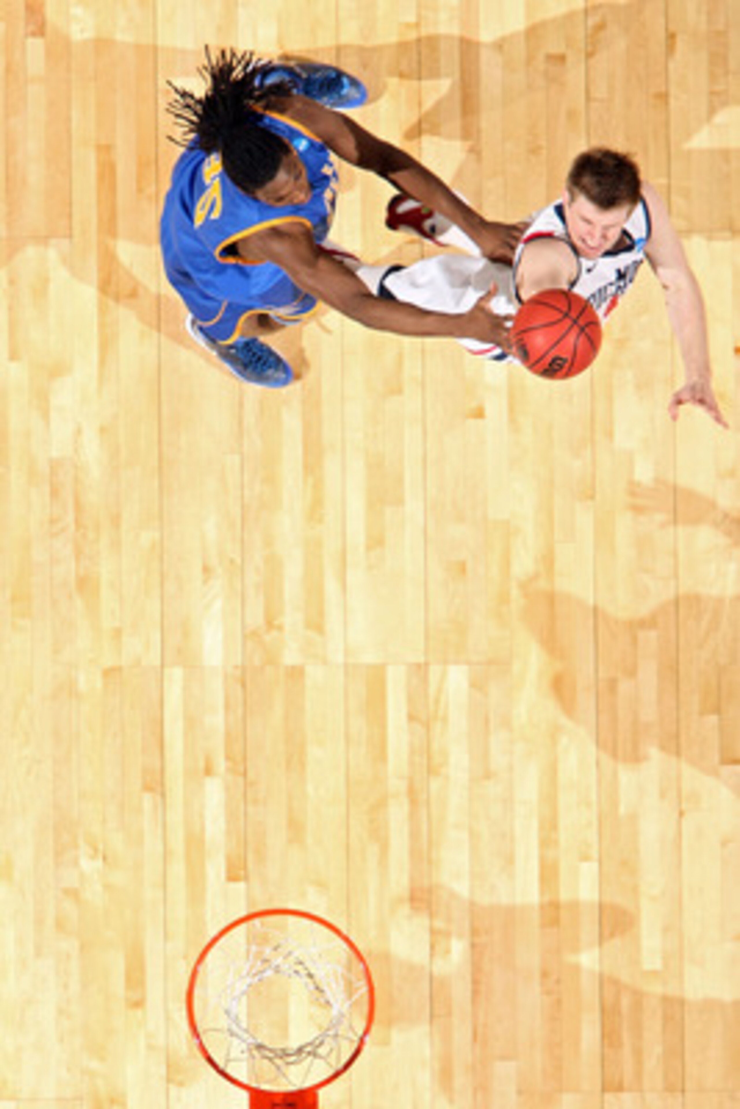 DENVER, CO - MARCH 19:  Dan Geriot #41 of the Richmond Spiders shoots the ball against Kenneth Faried #35 of the Morehead State Eagles during the third round of the 2011 NCAA men's basketball tournament at Pepsi Center on March 19, 2011 in Denver, Colorad