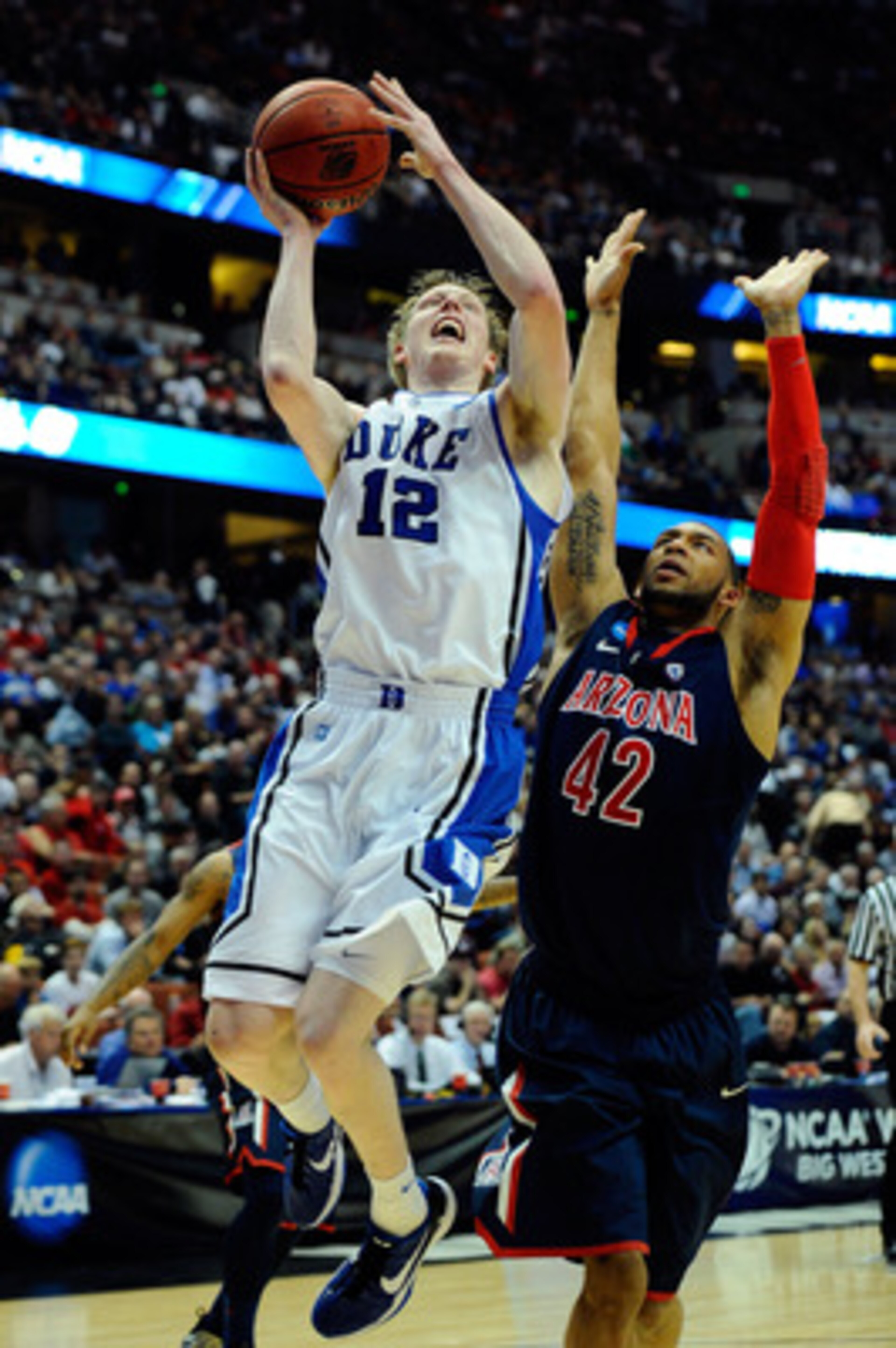 ANAHEIM, CA - MARCH 24: Kyle Singler #12 of the Duke Blue Devils goes to the basket against Jamelle Horne #42 of the Arizona Wildcats during the west regional semifinal of the 2011 NCAA men's basketball tournament at the Honda Center on March 24, 2011 in ANAHEIM, CA - MARCH 24: Kyle Singler #12 of the Duke Blue Devils goes to the basket against Jamelle Horne #42 of the Arizona Wildcats during the west regional semifinal of the 2011 NCAA men's basketball tournament at the Honda Center on March 24, 2011 in