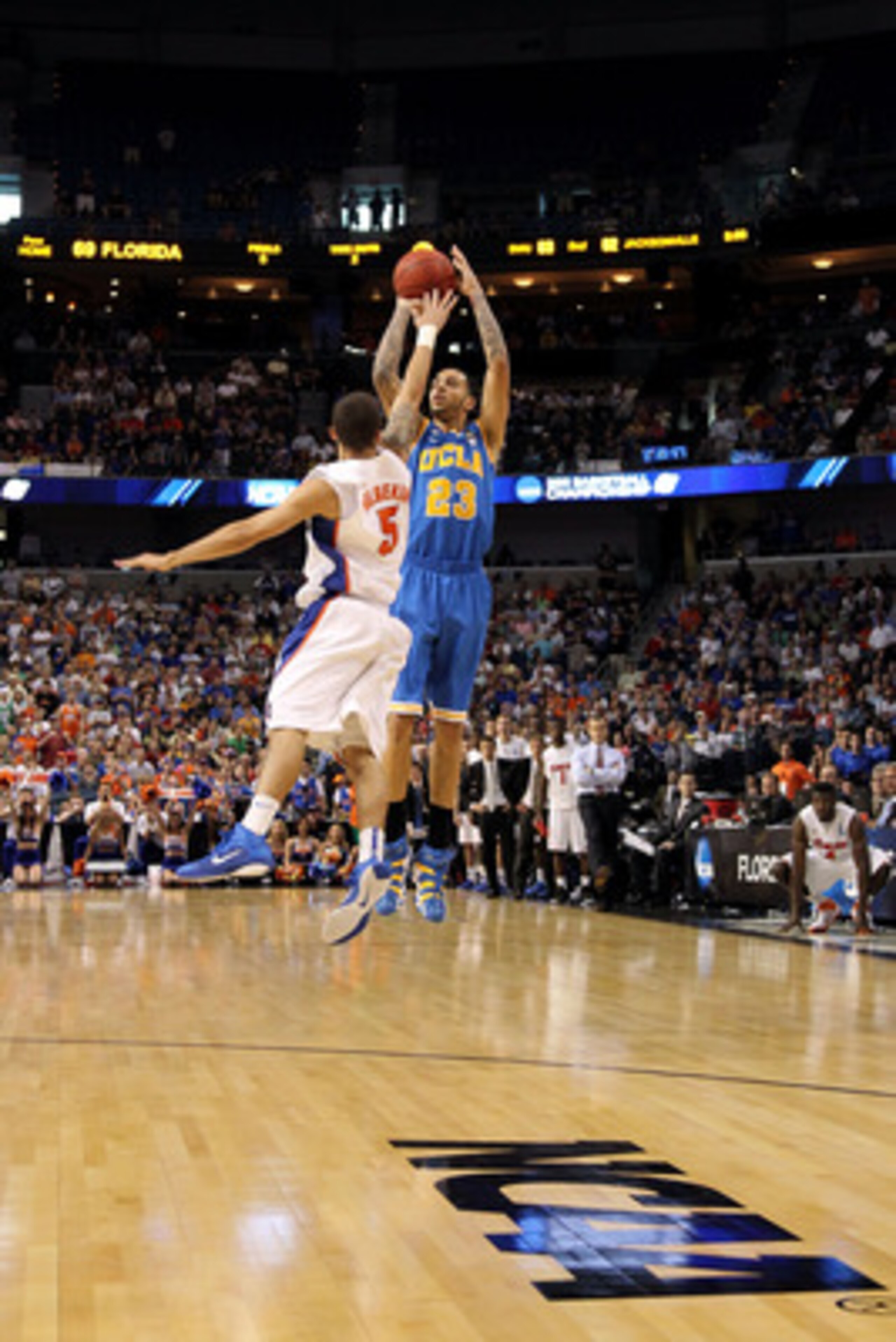 TAMPA, FL - MARCH 19:  Tyler Honeycutt #23 of the UCLA Bruins attempts a shot against Scottie Wilbekin #5 of the Florida Gators during the third round of the 2011 NCAA men's basketball tournament at St. Pete Times Forum on March 19, 2011 in Tampa, Florida