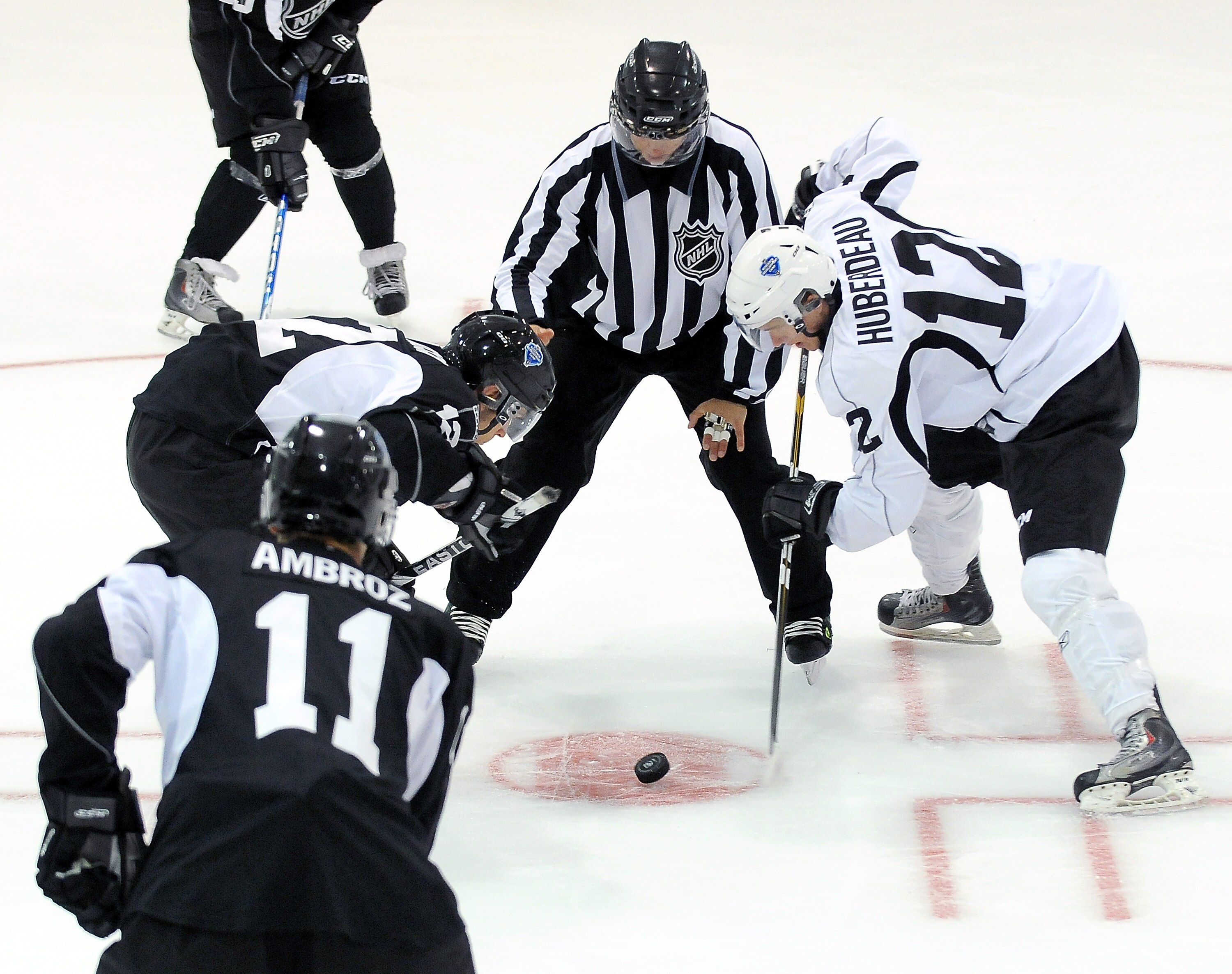 TORONTO, ON - AUGUST 18: Jonathan Huberdeau, #12 (white), takes a face-off where new face-off violation lines were tested by the NHL during an on-ice session at the 2010 NHL Research, Development and Orientation Camp fueled by G Series on August 18, 2010 