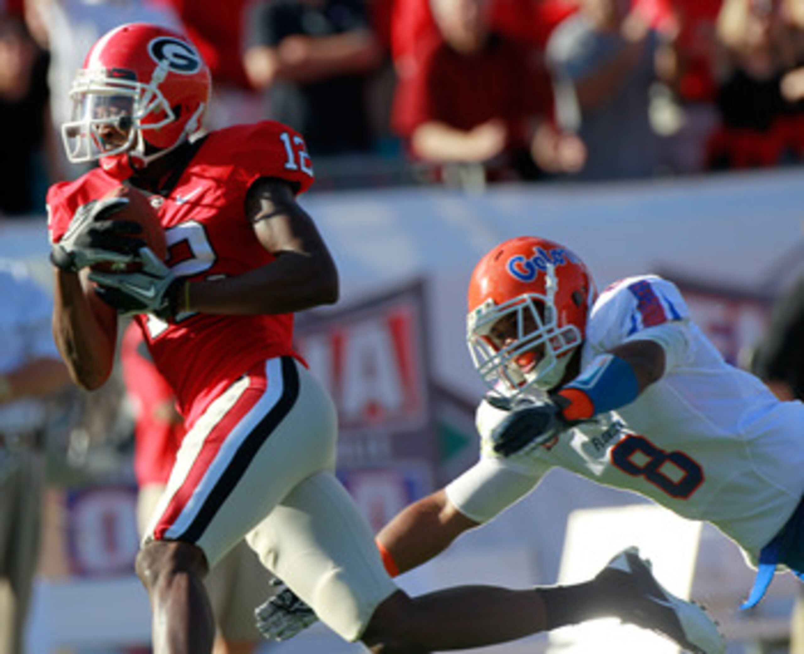 JACKSONVILLE, FL - OCTOBER 30:  Jeremy Brown #8 of the Florida Gators attempts to tackle Tavarres King #12 of the Georgia Bulldogs during the game at EverBank Field on October 30, 2010 in Jacksonville, Florida.  (Photo by Sam Greenwood/Getty Images)