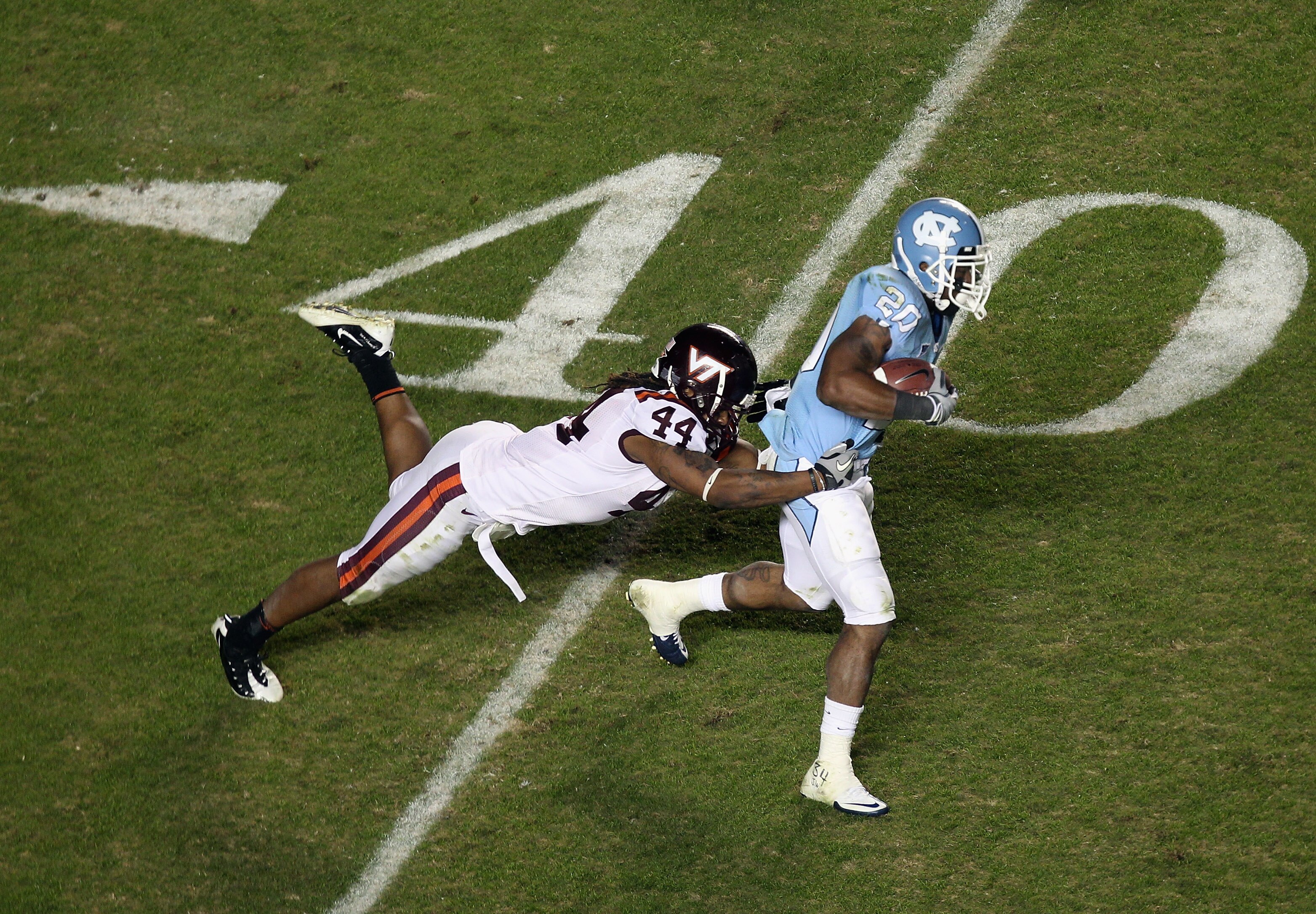 CHAPEL HILL, NC - NOVEMBER 13:  Lyndell Gibson #44 of the Virginia Tech Hokies tackles Shaun Draughn #20 of the North Carolina Tar Heels during their game at Kenan Stadium on November 13, 2010 in Chapel Hill, North Carolina.  (Photo by Streeter Lecka/Gett